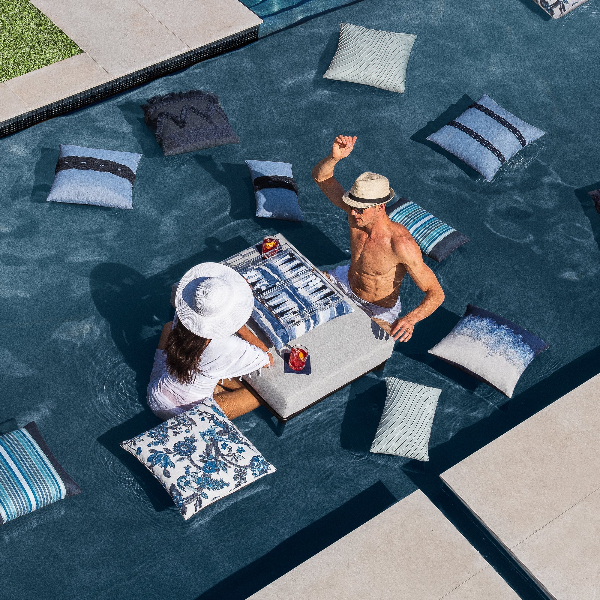 Luxury slate blue subtle patterned decorative pillow on a outdoor sofa styled for hospitality suites, featuring easy clean performance fabric for luxury hotel and resort design by Elaine Smith