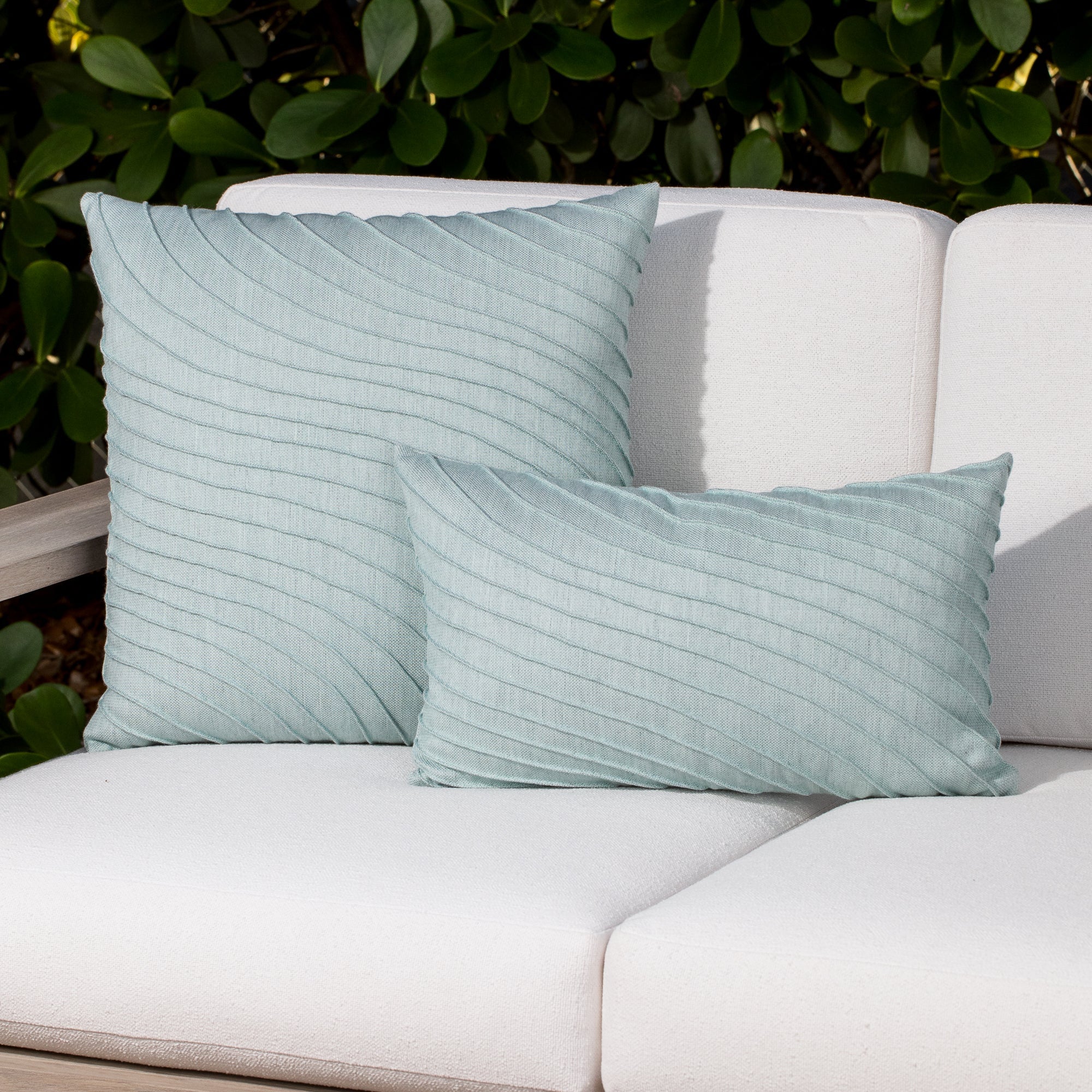 Luxury slate blue subtle patterned decorative pillow on a outdoor sofa styled for hospitality suites, featuring easy clean performance fabric for luxury hotel and resort design by Elaine Smith