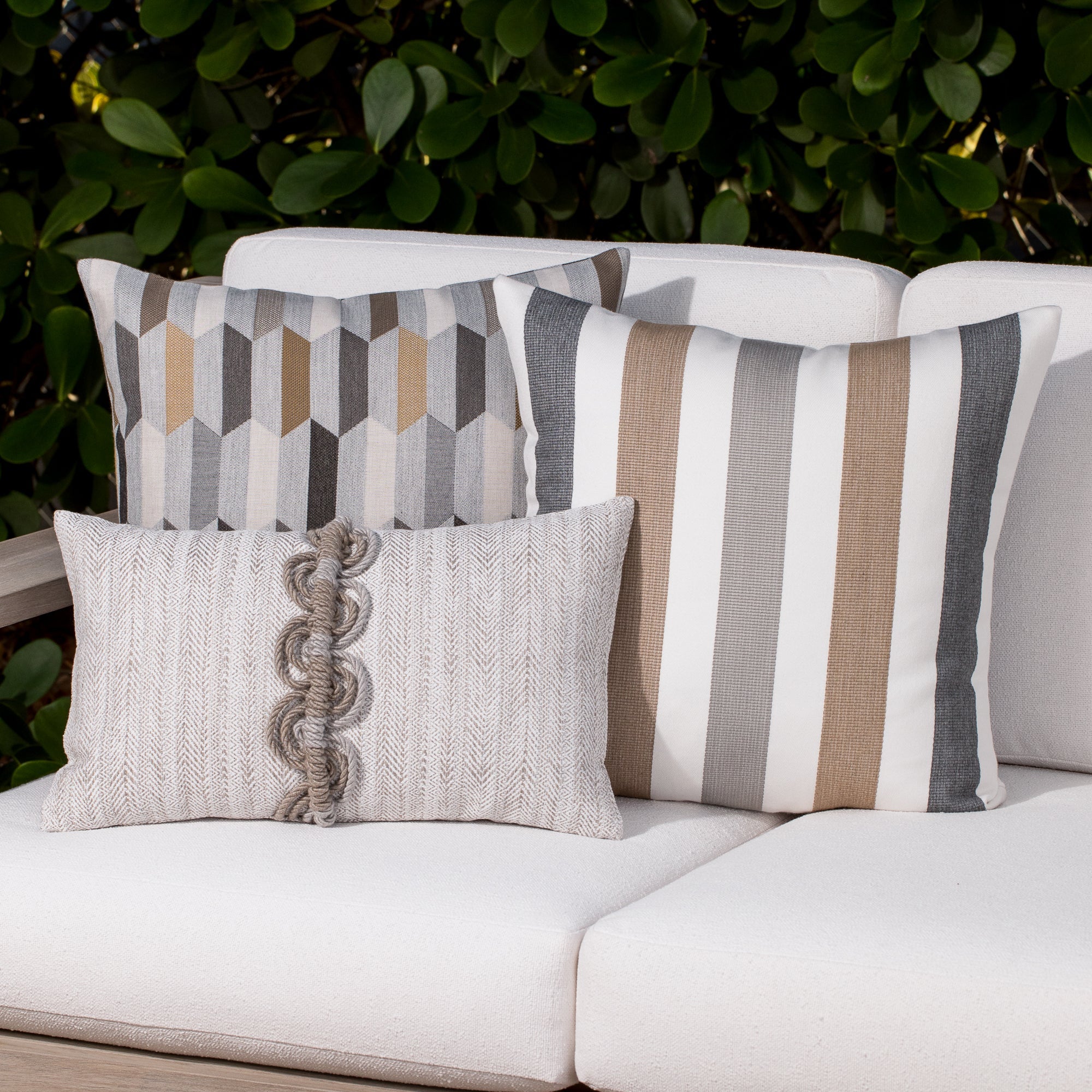 Outdoor image of pillows in Dune Stripe – outdoor-safe woven fabric by Elaine Smith, ideal for high-end commercial and residential applications.