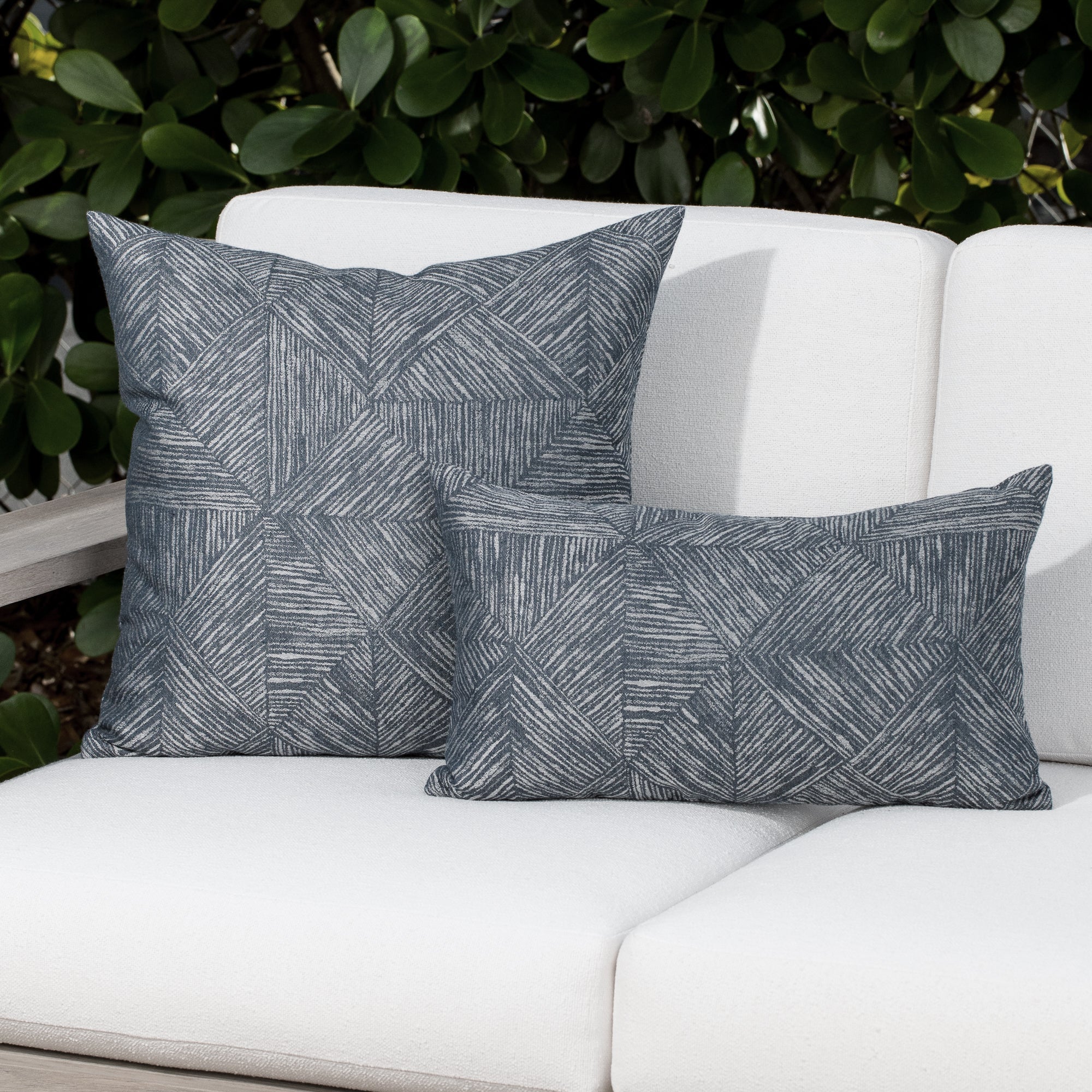 Luxury denim and gray modern patterned decorative pillow on a outdoor sofa, featuring weather resistant performance fabric for indoor and outdoor use by Elaine Smith