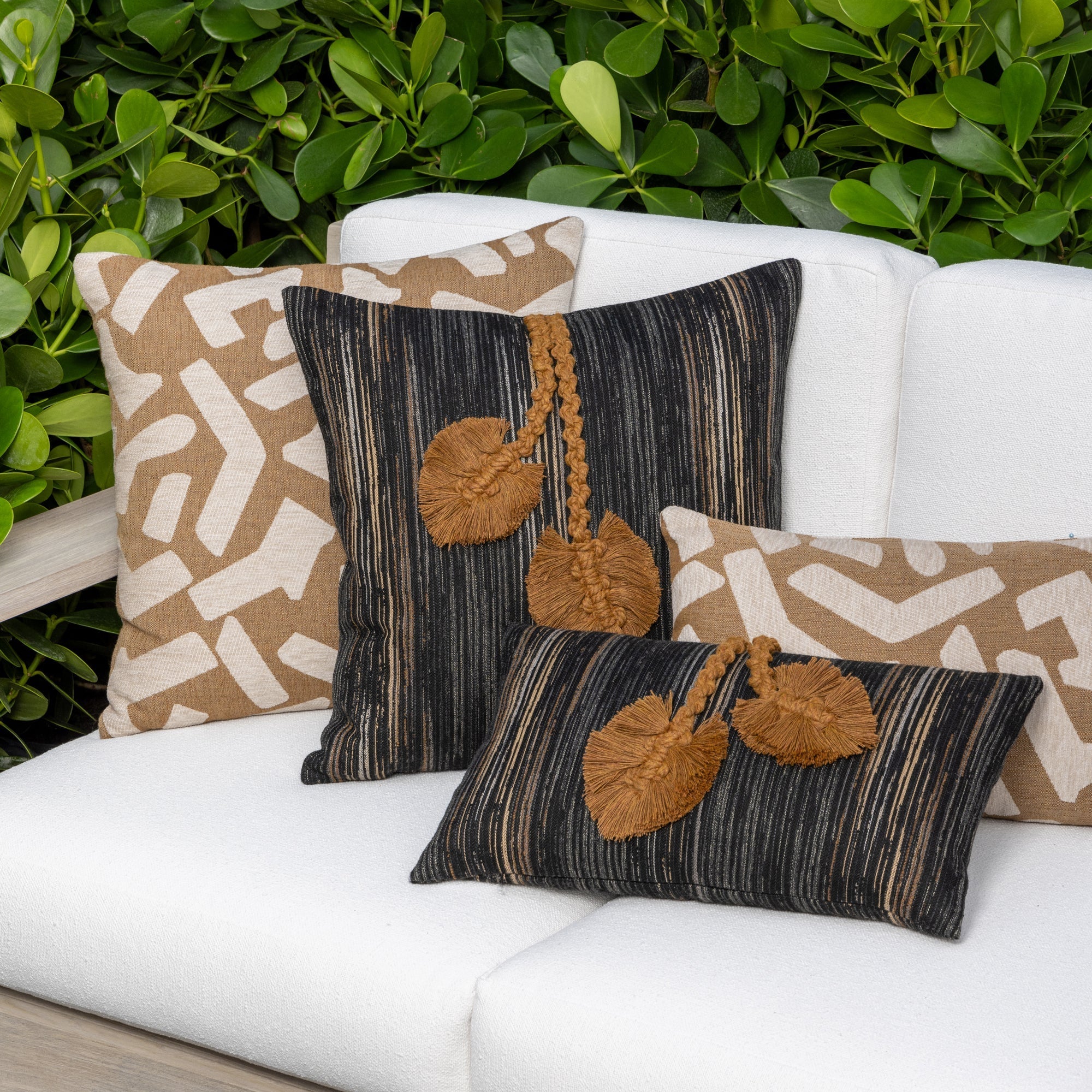 Luxury charcoal and sepia botanical patterned decorative pillow on a outdoor sofa, featuring rich texture for layered decor for indoor and outdoor use