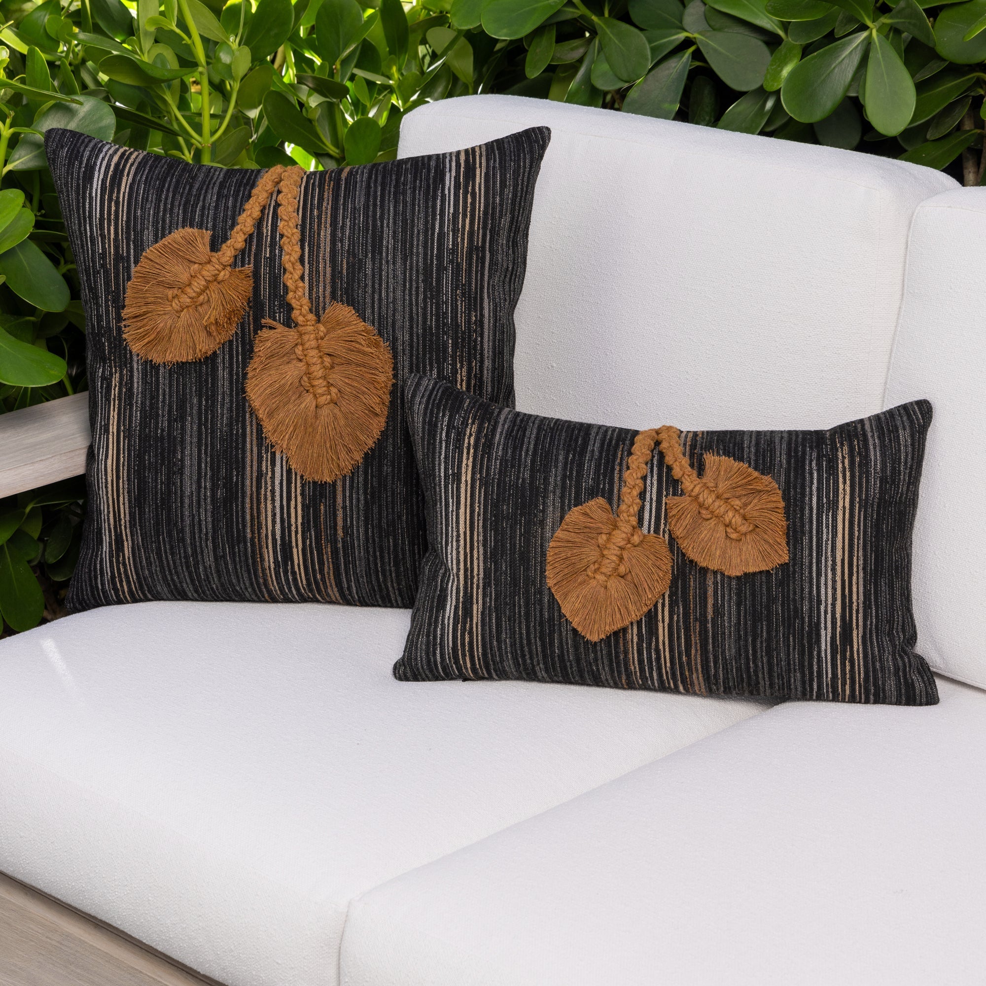 Luxury charcoal and sepia botanical patterned decorative pillow on a outdoor sofa, featuring rich texture for layered decor for indoor and outdoor use
