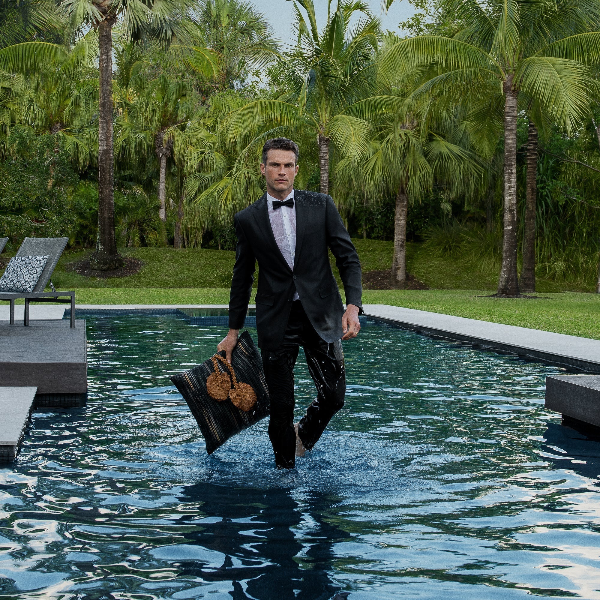 Luxury charcoal and sepia botanical patterned decorative pillow on a outdoor sofa, featuring rich texture for layered decor for indoor and outdoor use