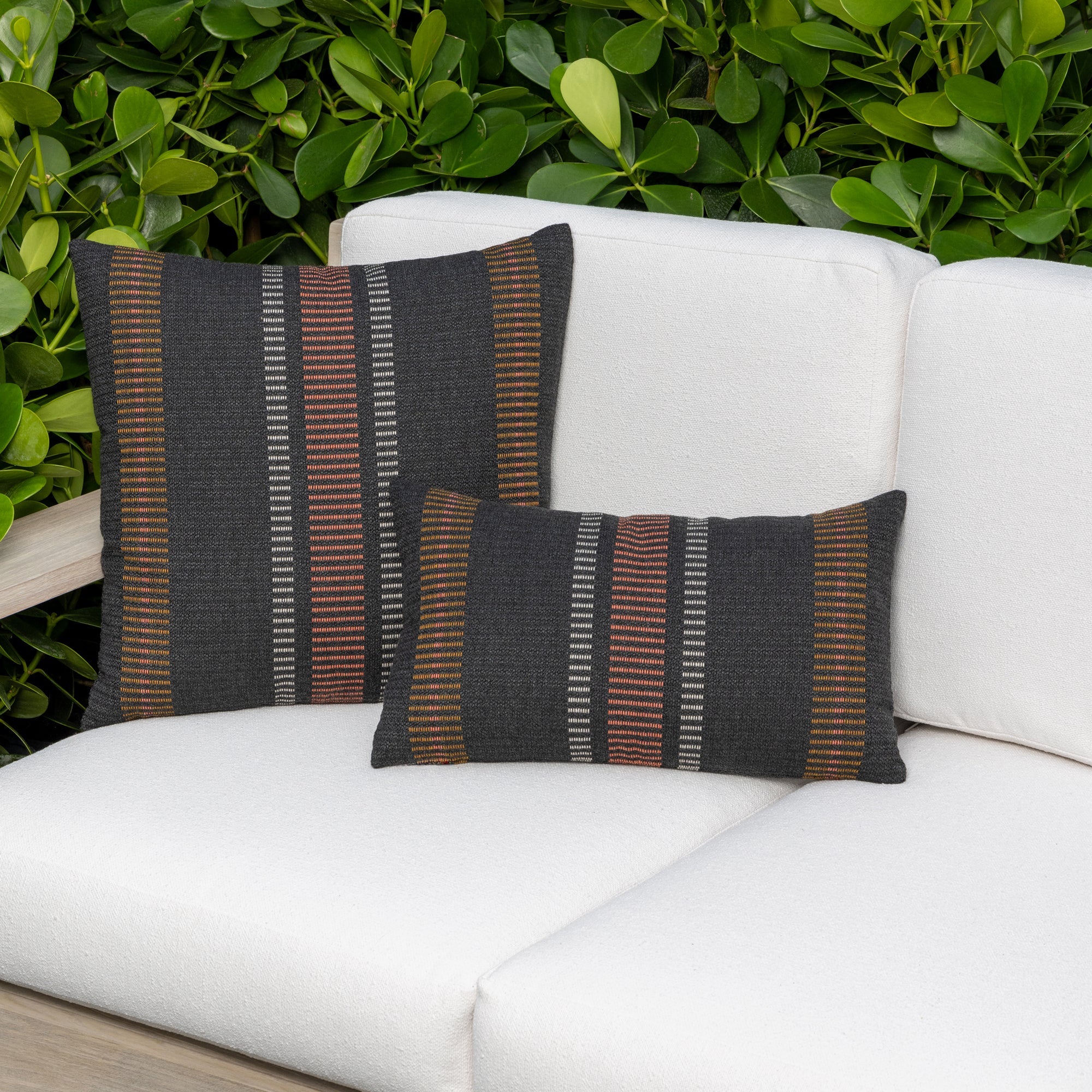Outdoor image of pillows in Earth-toned woven outdoor safe fabric with subtle stripe detailing – Journey Earth by Elaine Smith