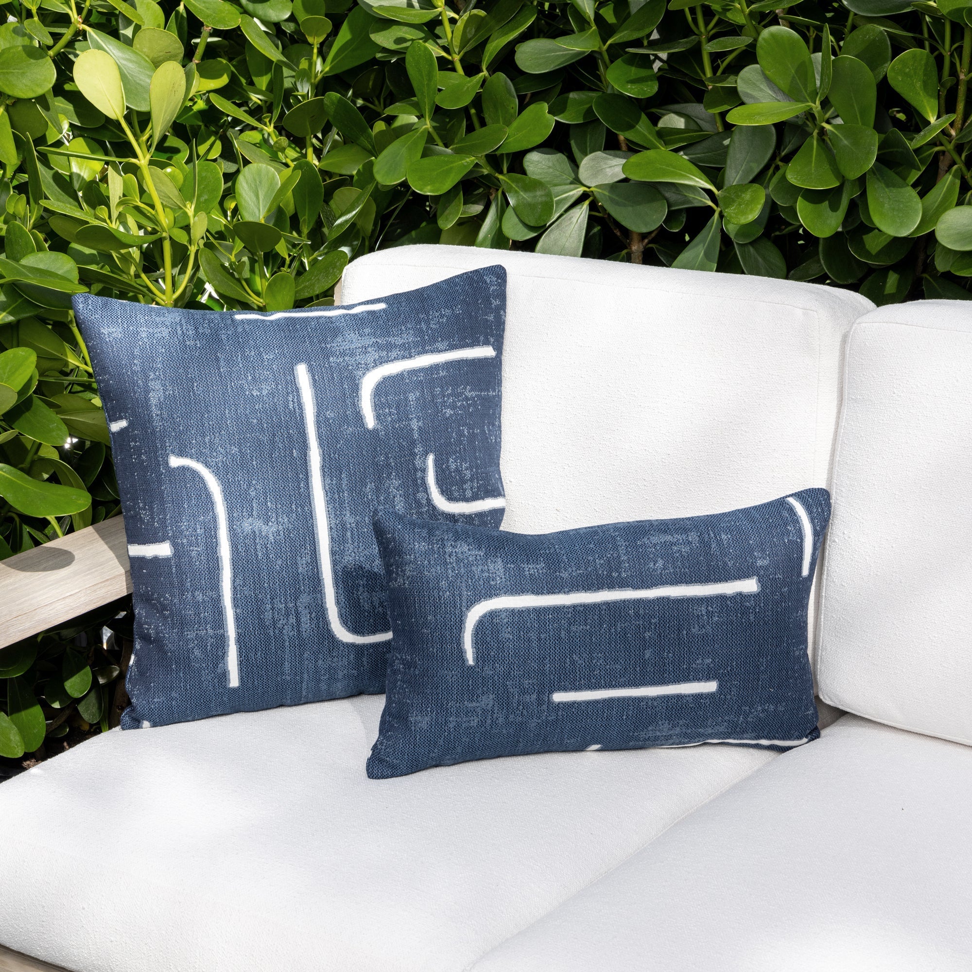 Luxury denim and  white modern patterned accent pillow on a outdoor sofa, featuring tailored seams for a polished look to complete indoor and outdoor decor by Elaine Smith