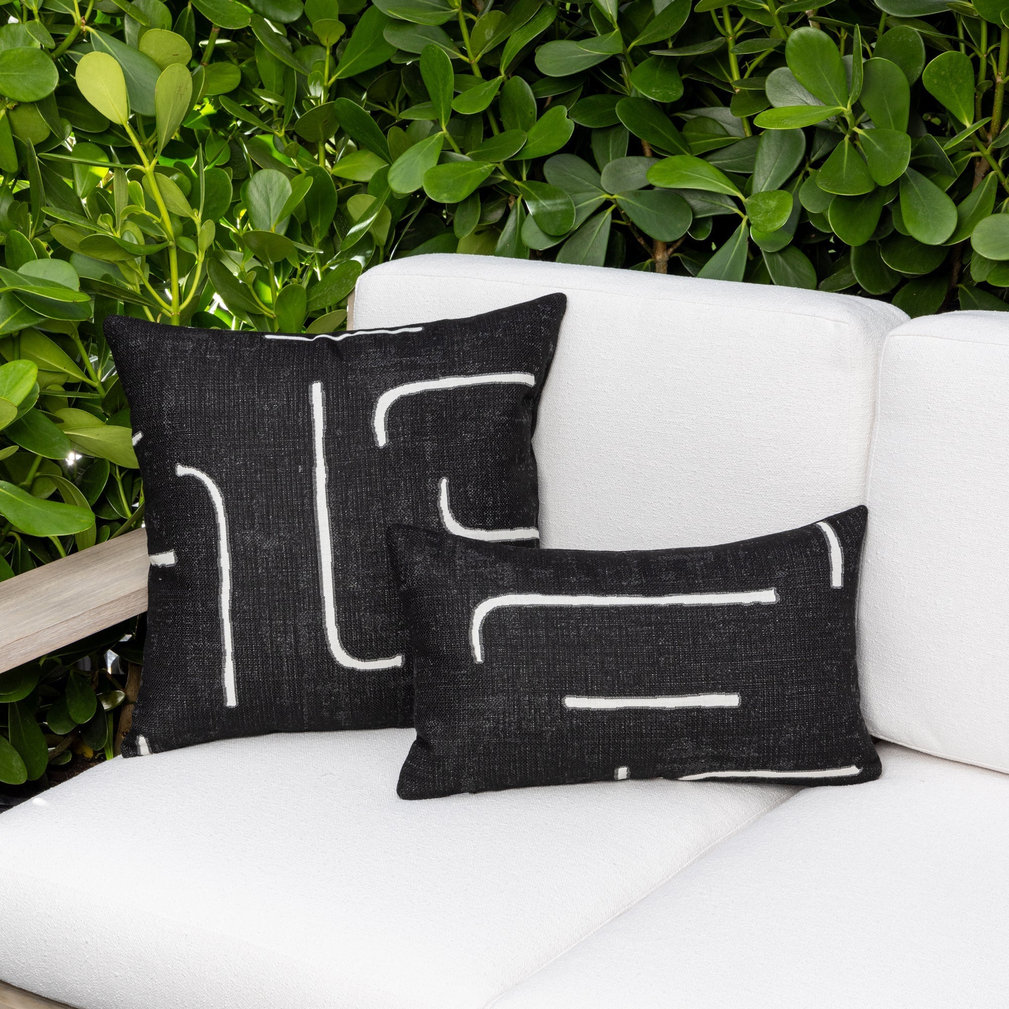 Luxury black and white modern patterned accent pillow on a outdoor sofa, featuring tailored seams for a polished look to complete indoor and outdoor decor by Elaine Smith