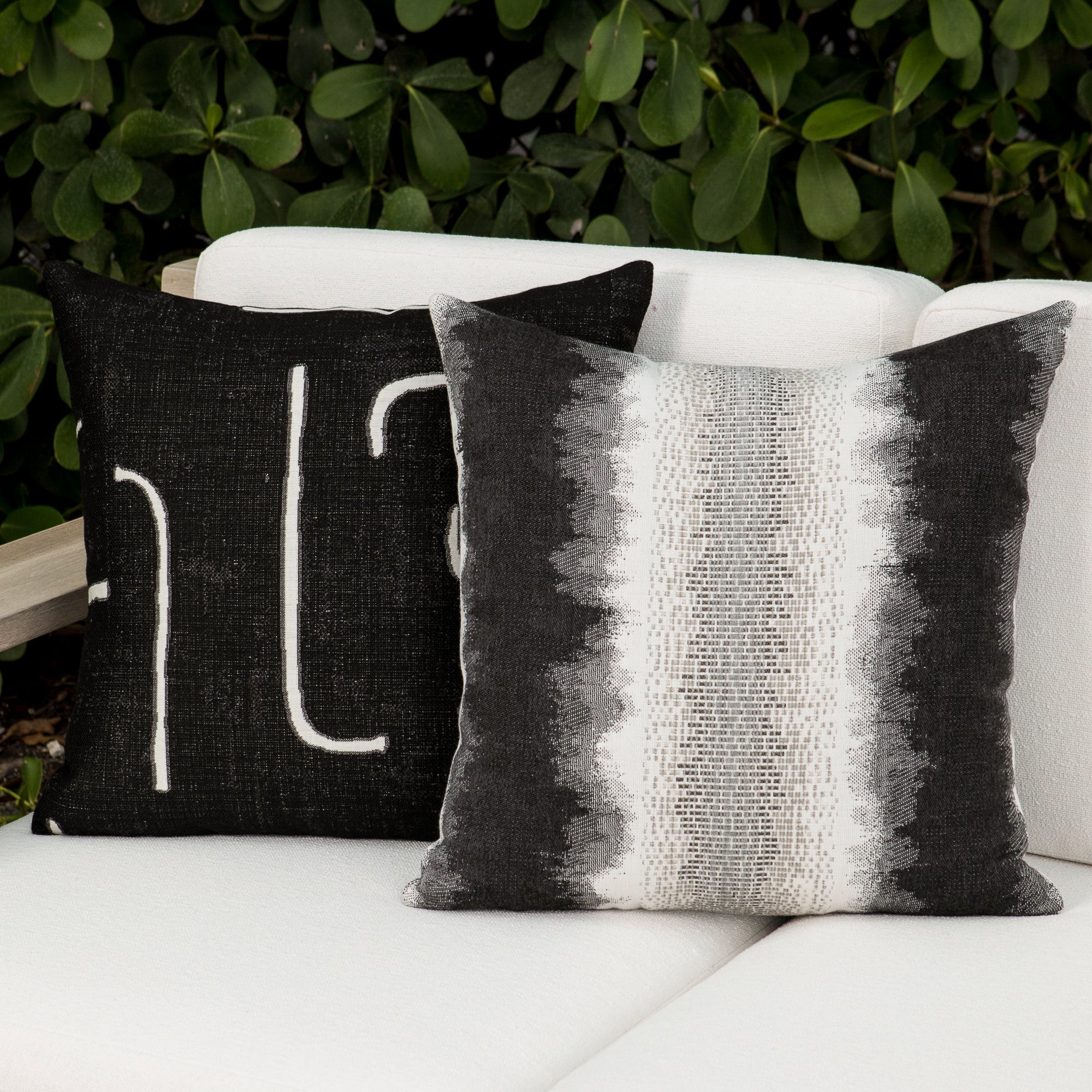 Luxury black and white modern patterned accent pillow on a outdoor sofa, featuring tailored seams for a polished look to complete indoor and outdoor decor by Elaine Smith
