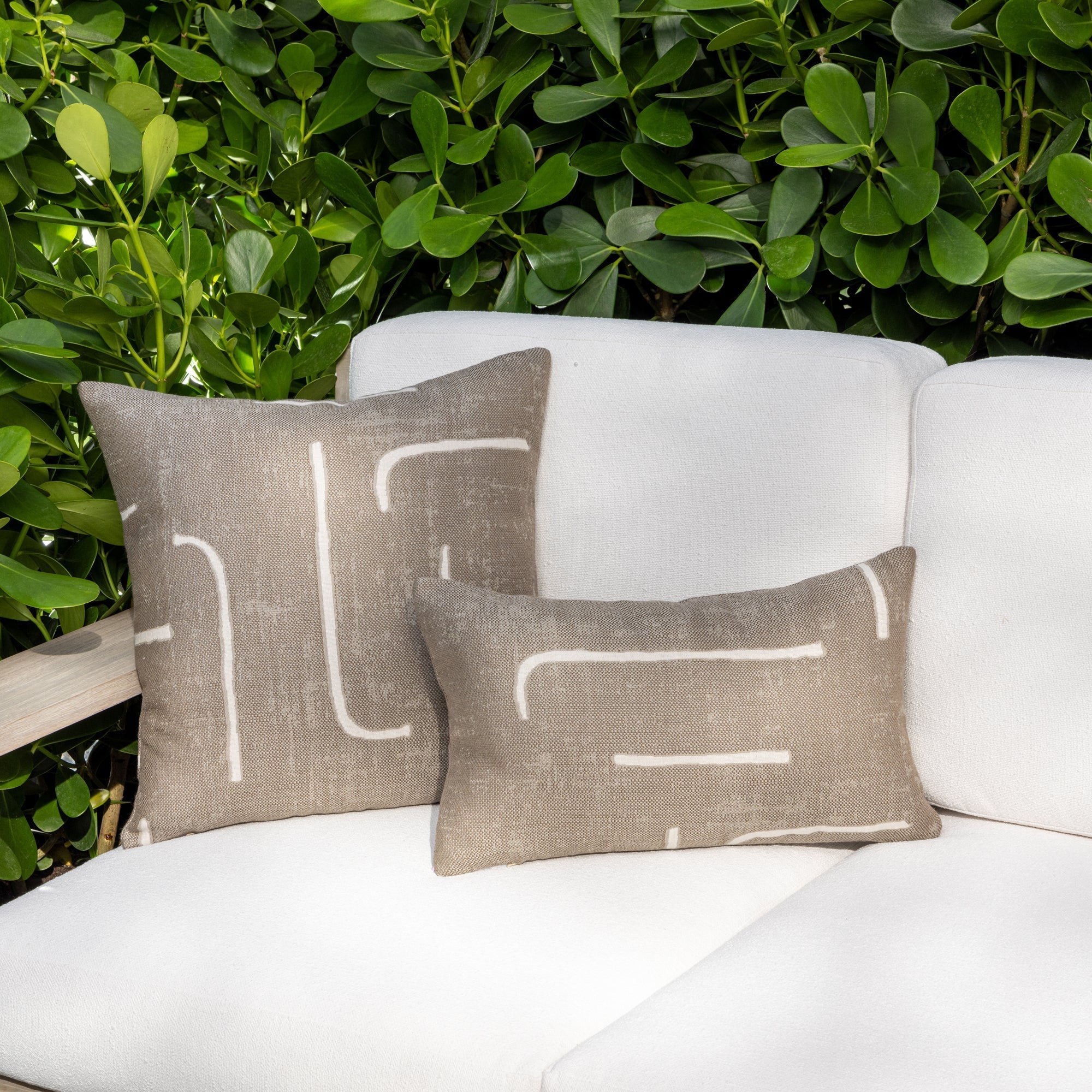 Luxury taupe and white modern patterned accent pillow on a outdoor sofa, featuring tailored seams for a polished look to complete indoor and outdoor decor by Elaine Smith