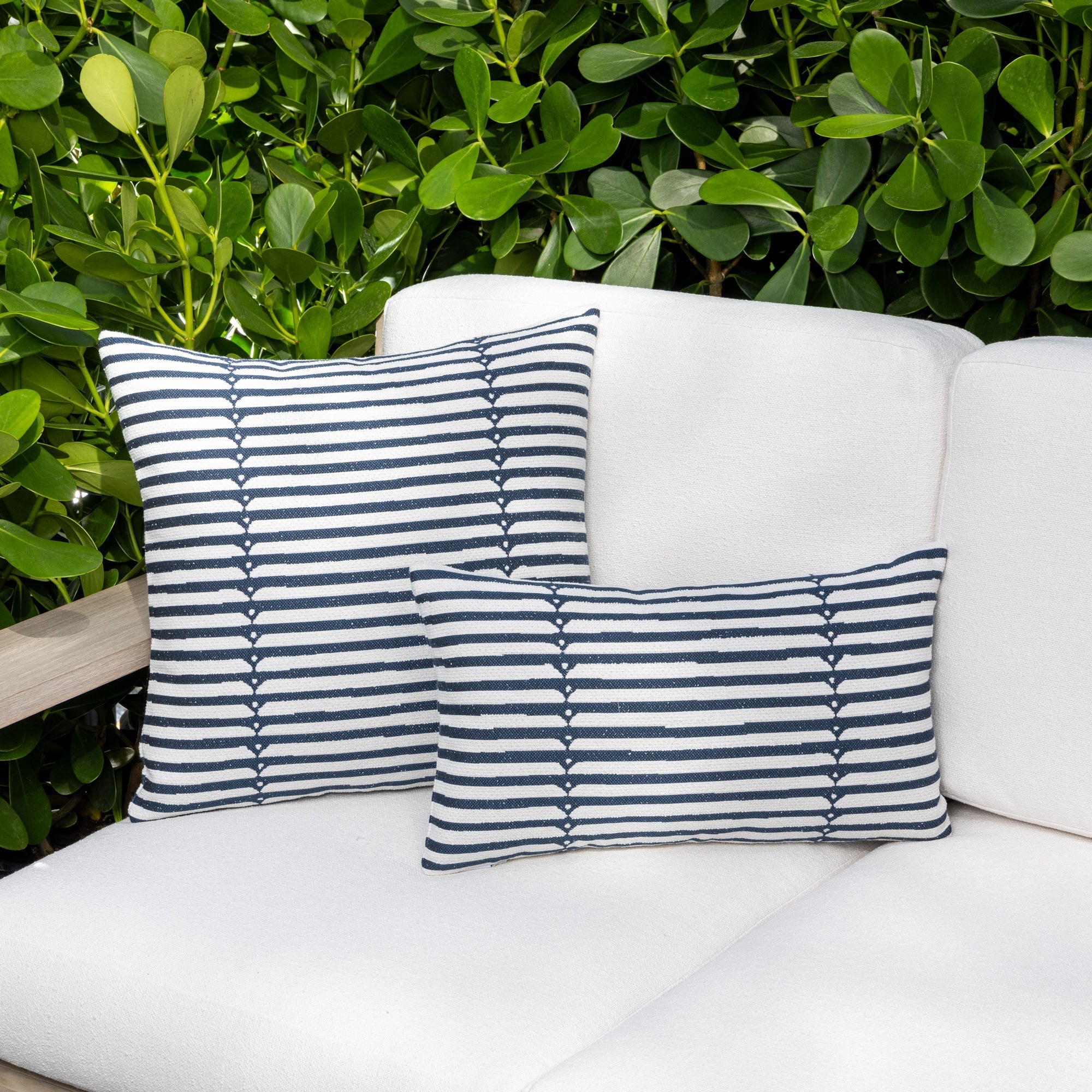 Luxury denim and  white modern patterned accent pillow on a outdoor sofa, featuring tailored seams for a polished look to complete indoor and outdoor decor by Elaine Smith
