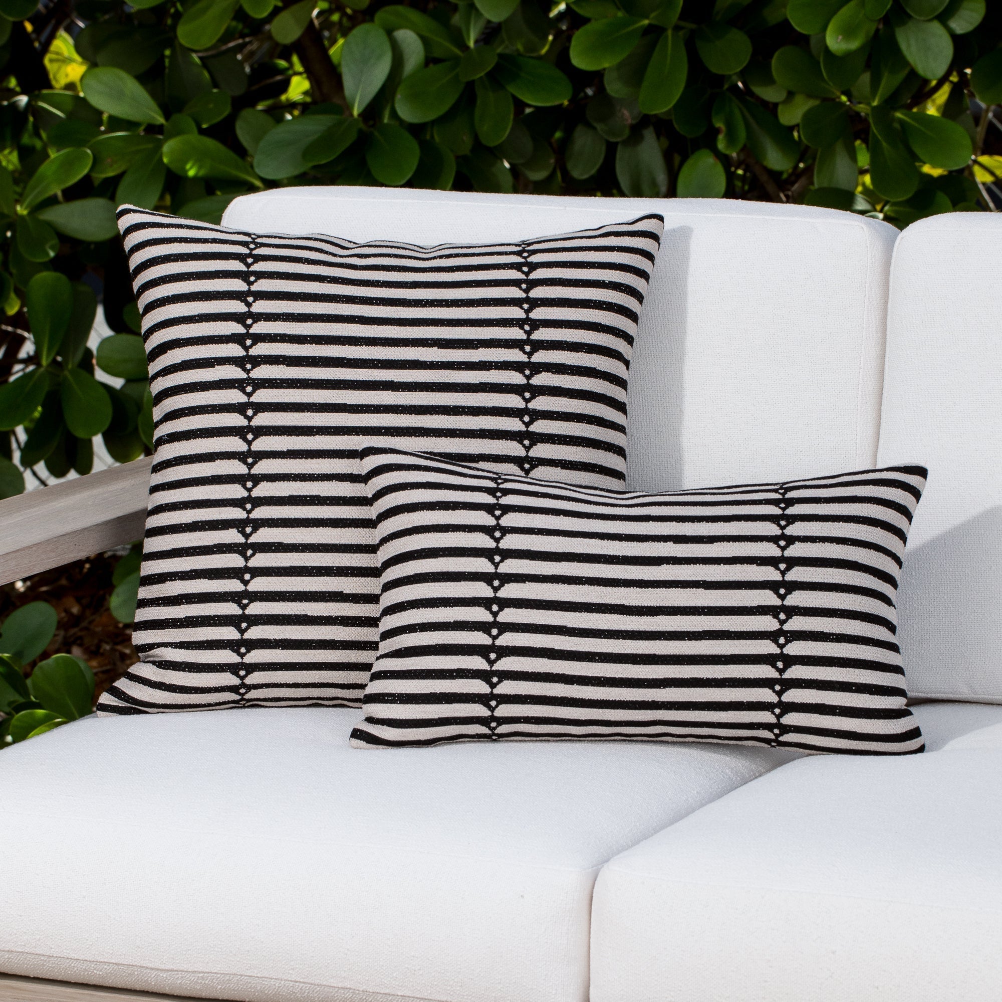 Luxury black and white modern patterned accent pillow on a outdoor sofa, featuring tailored seams for a polished look to complete indoor and outdoor decor by Elaine Smith