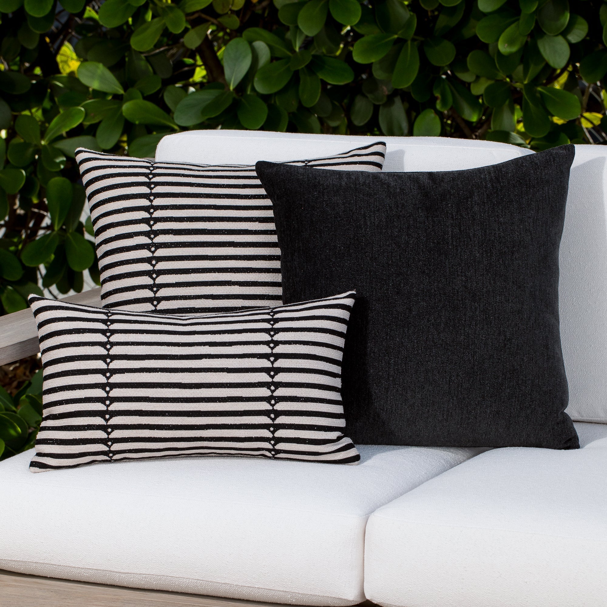 Luxury black and white modern patterned accent pillow on a outdoor sofa, featuring tailored seams for a polished look to complete indoor and outdoor decor by Elaine Smith