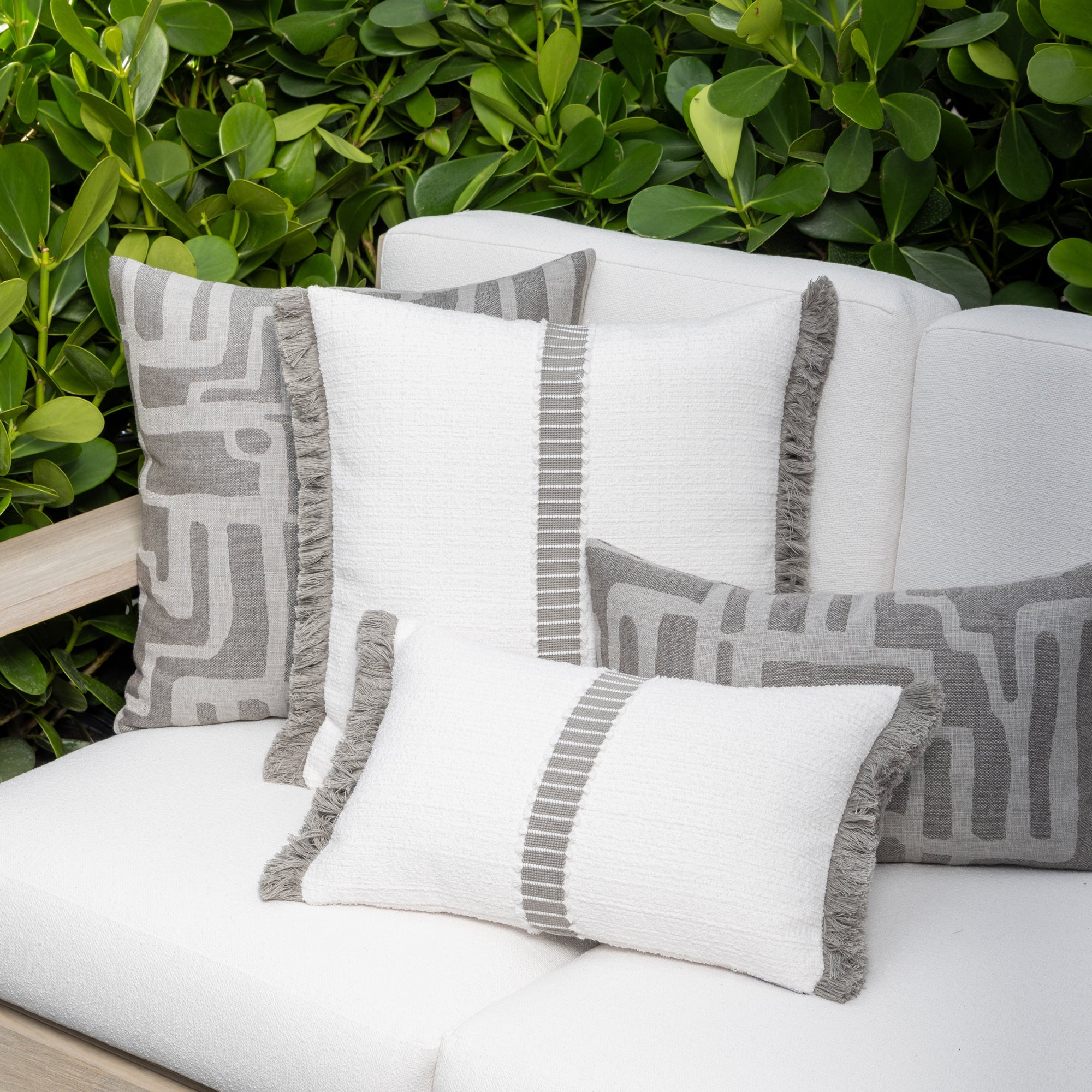 Outdoor image of pillows in Pewter gray abstract linear outdoor safe woven fabric