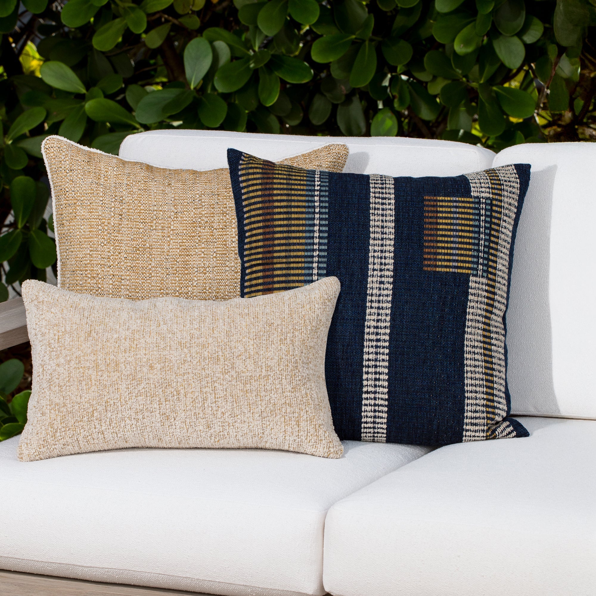 Luxury honey solid and other decorative pillow on a outdoor sofa styled for hospitality suites, featuring weather resistant performance fabric for indoor and outdoor use by Elaine Smith