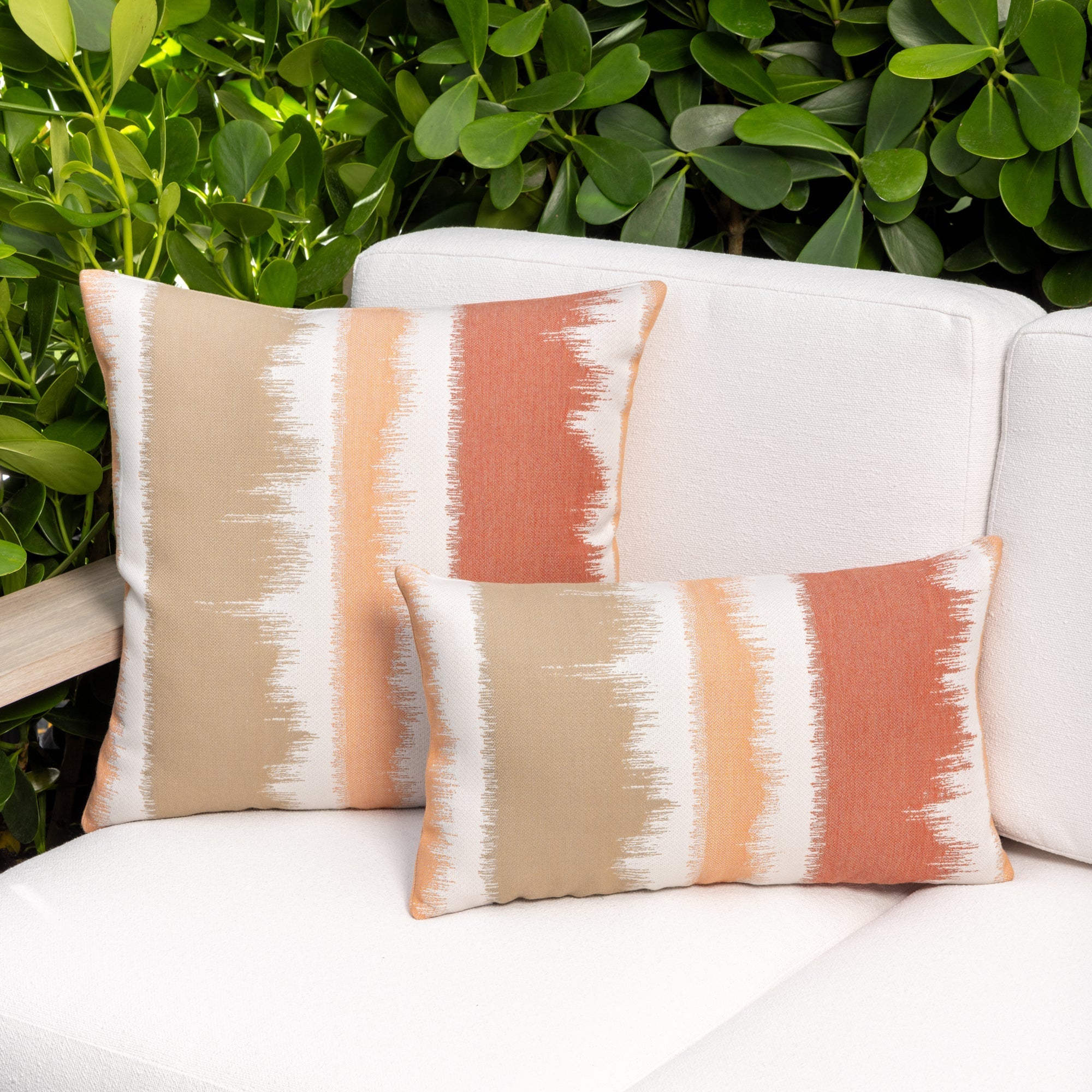 Luxury coral two tone cushion on a rooftop seating area, featuring tailored seams for a polished look to complete indoor and outdoor decor by Elaine Smith