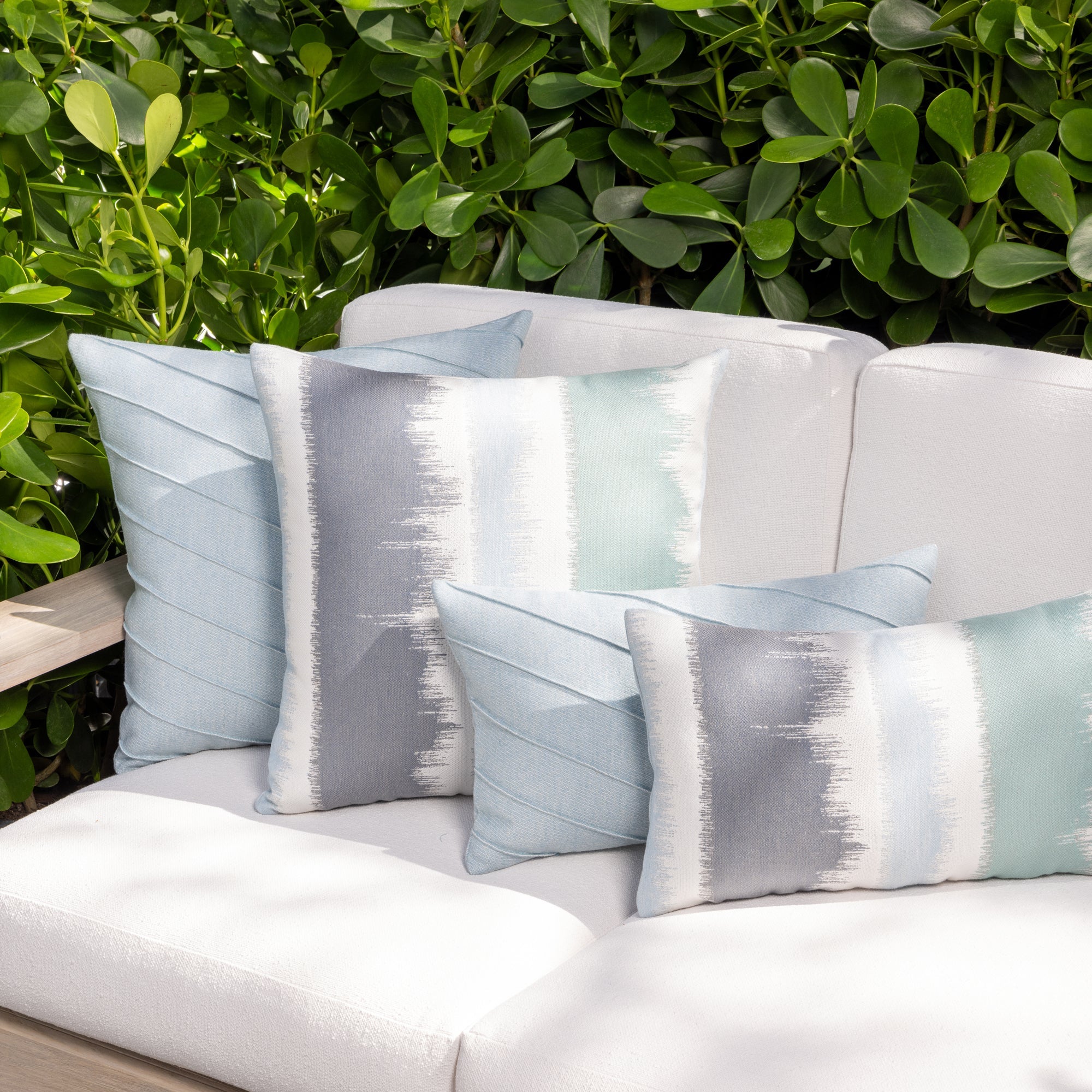 Outdoor image of pillows in Soft pastel blue woven outdoor safe fabric with airy feel