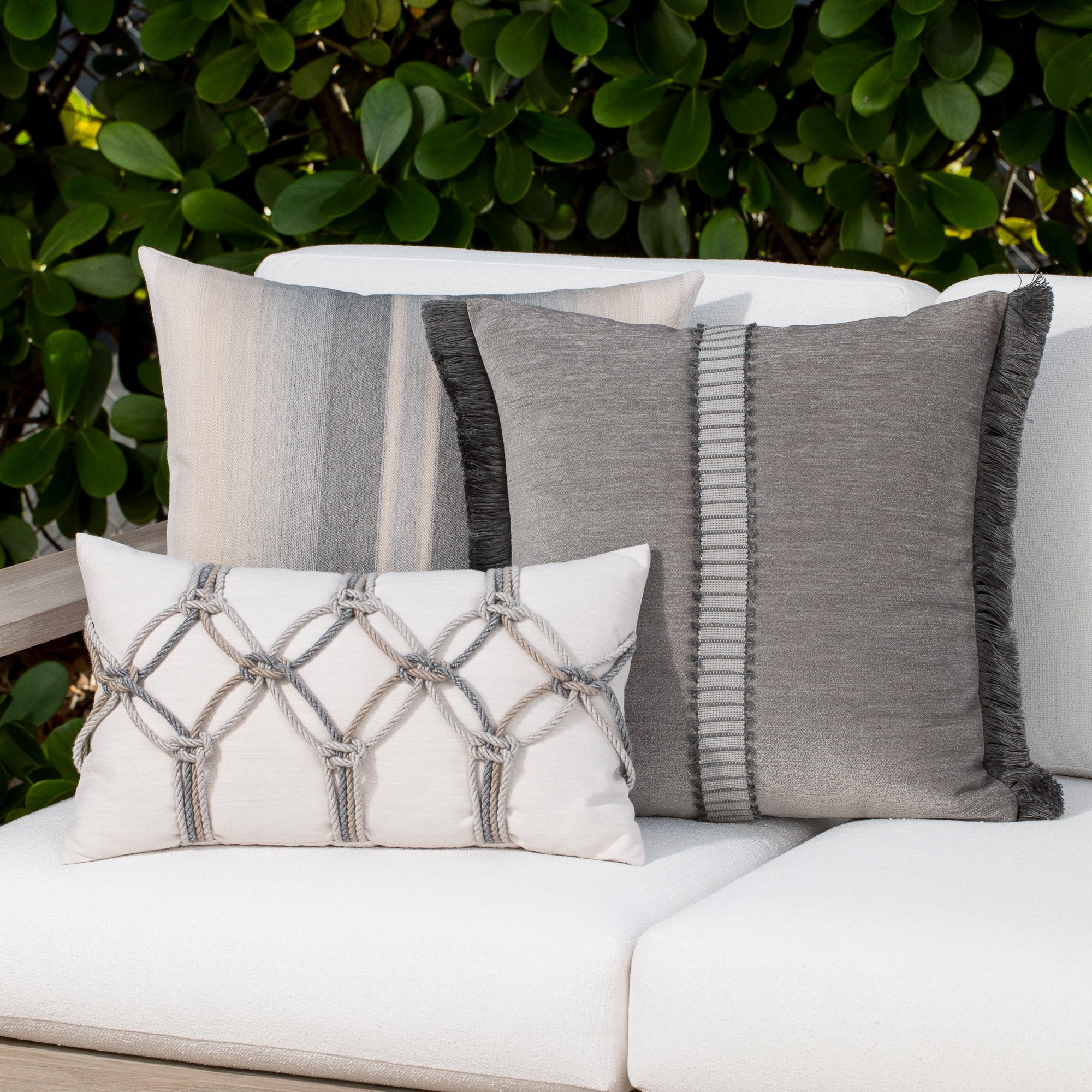 Luxury taupe textured woven cushion on a outdoor sofa, featuring all weather performance construction for residential and commercial interiors
