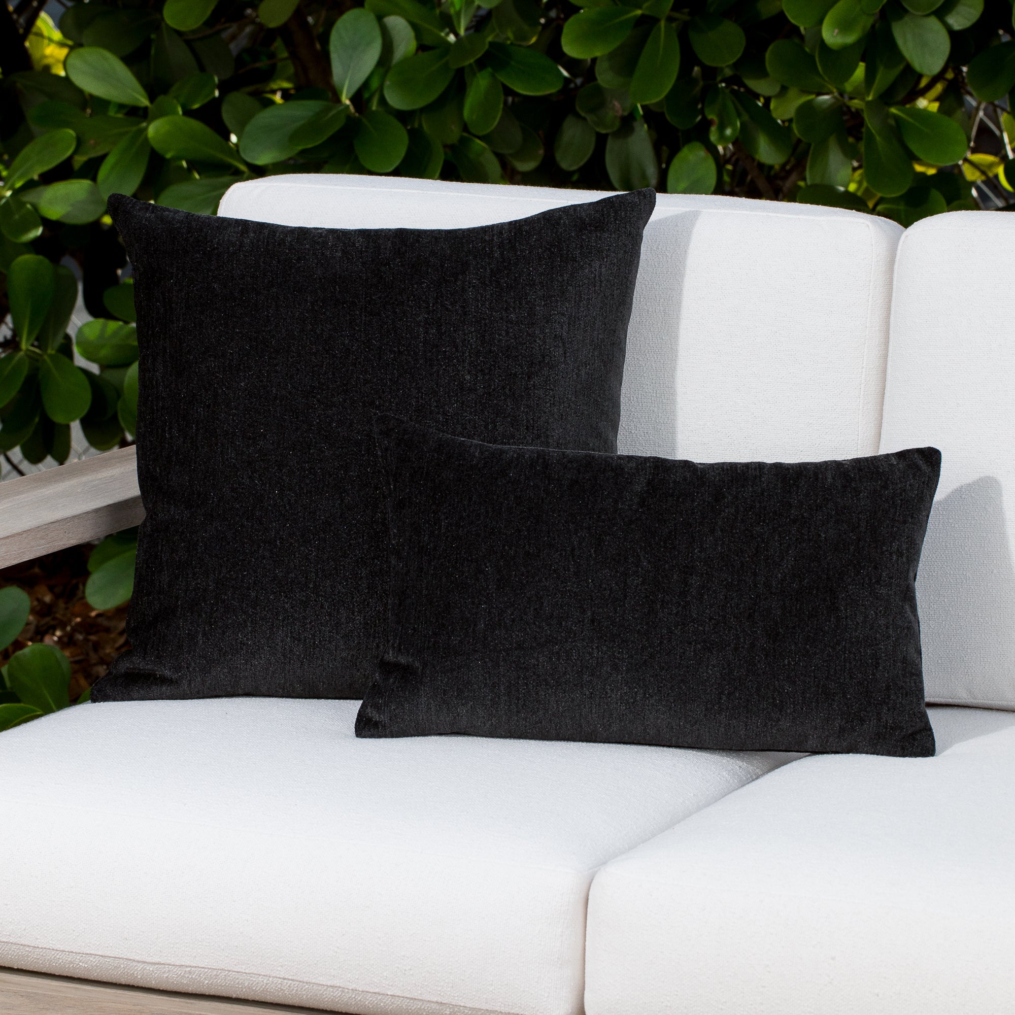 Luxury blue and navy two tone decorative pillow on a outdoor sofa, featuring commercial grade construction for luxury hotel and resort design