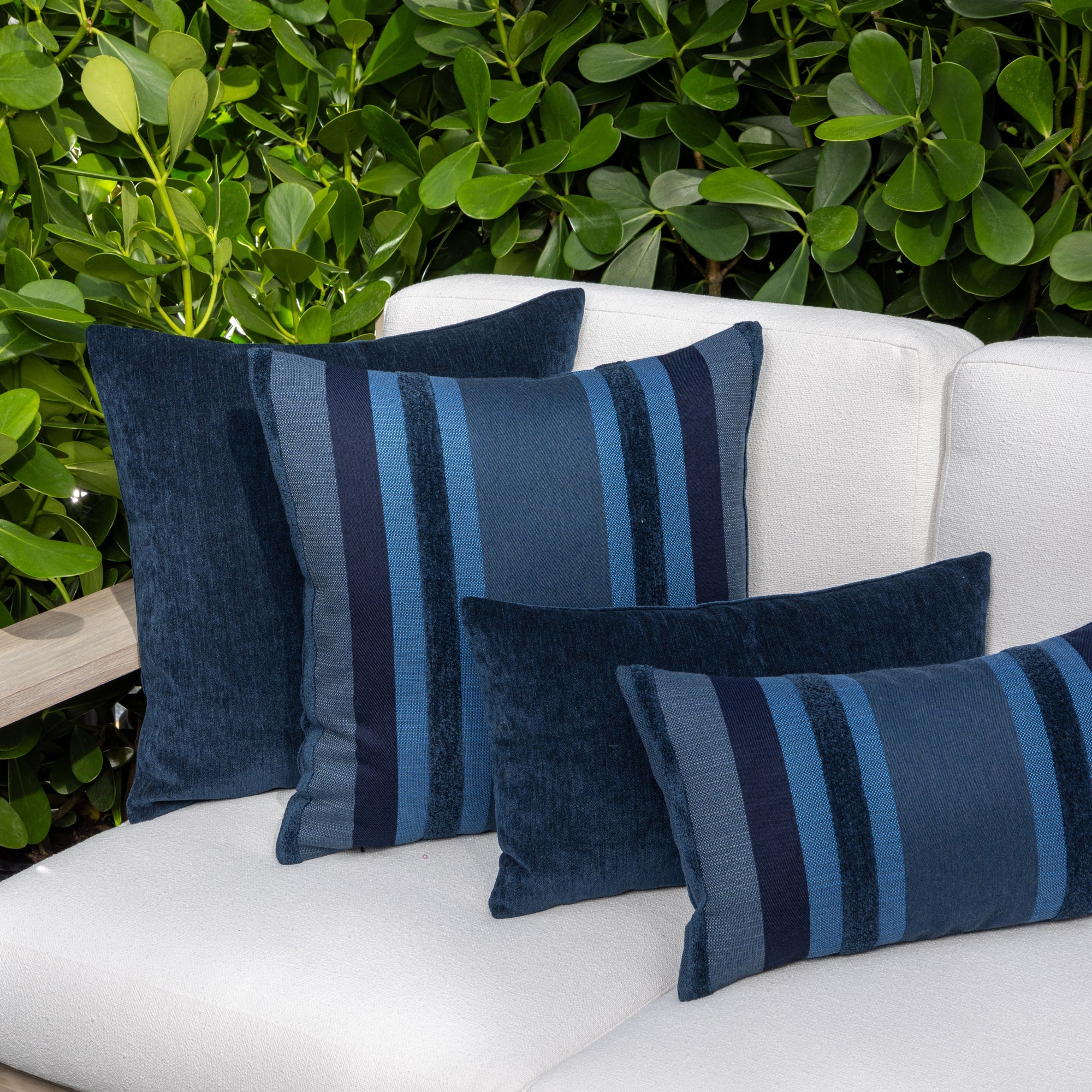Outdoor image of pillows in Outdoor safe woven fabric with vertical indigo stripe pattern with rich bands of chenille– Intermix Indigo by Elaine Smith