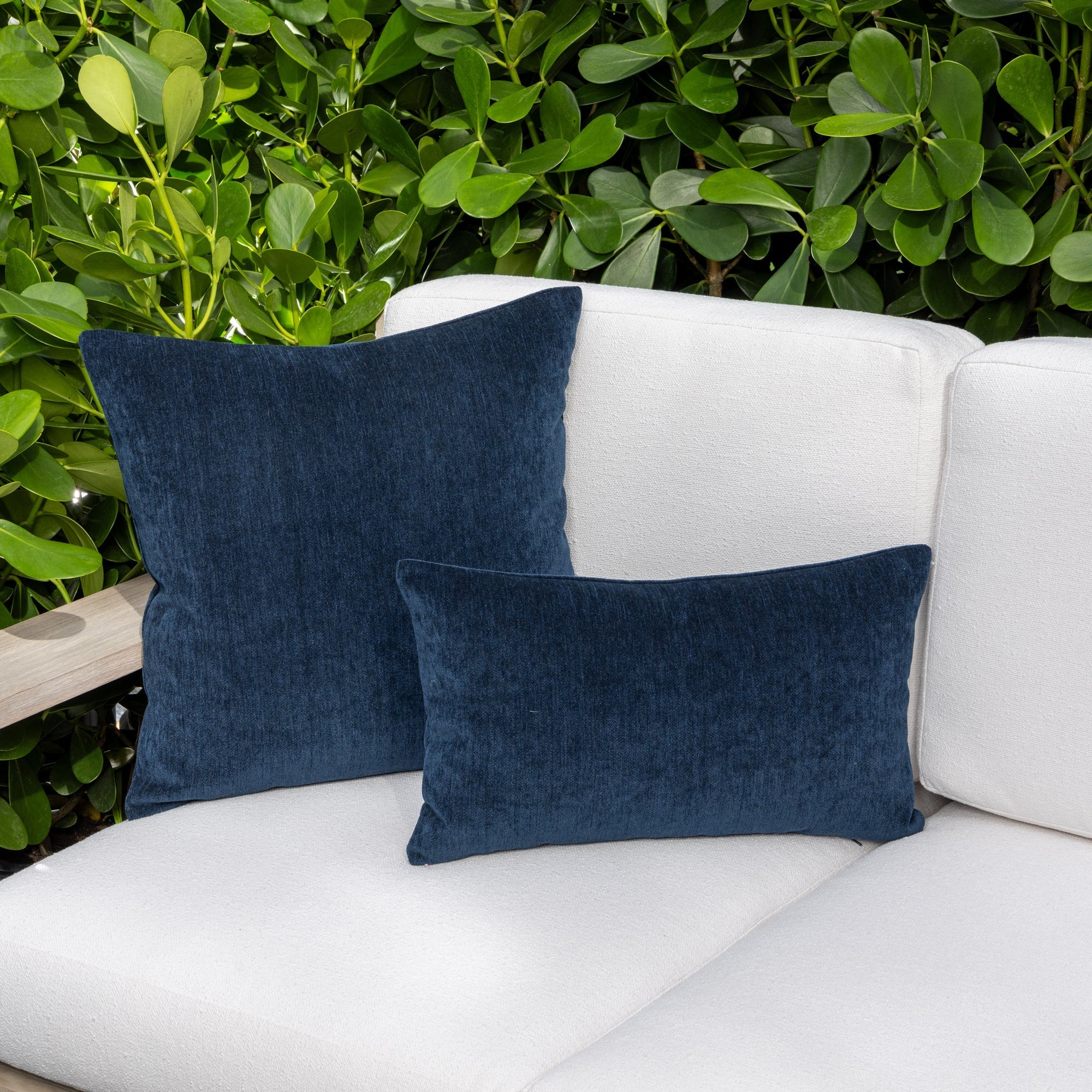 Luxury blue and navy two tone decorative pillow on a outdoor sofa, featuring commercial grade construction for luxury hotel and resort design