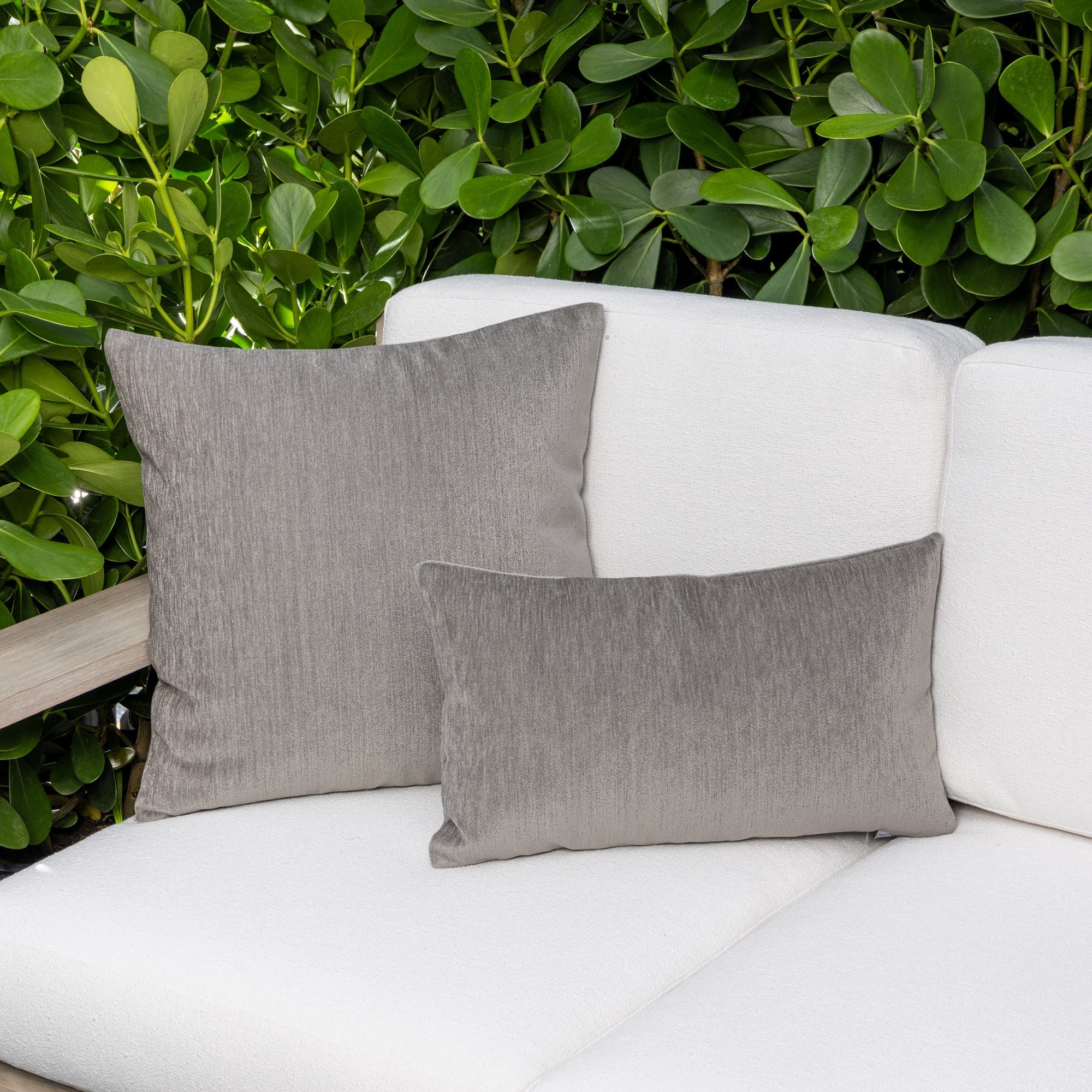 Luxury pewter solid cushion on an indoor and outdoor sofa, featuring solution dyed performance fibers for hospitality and commercial spaces