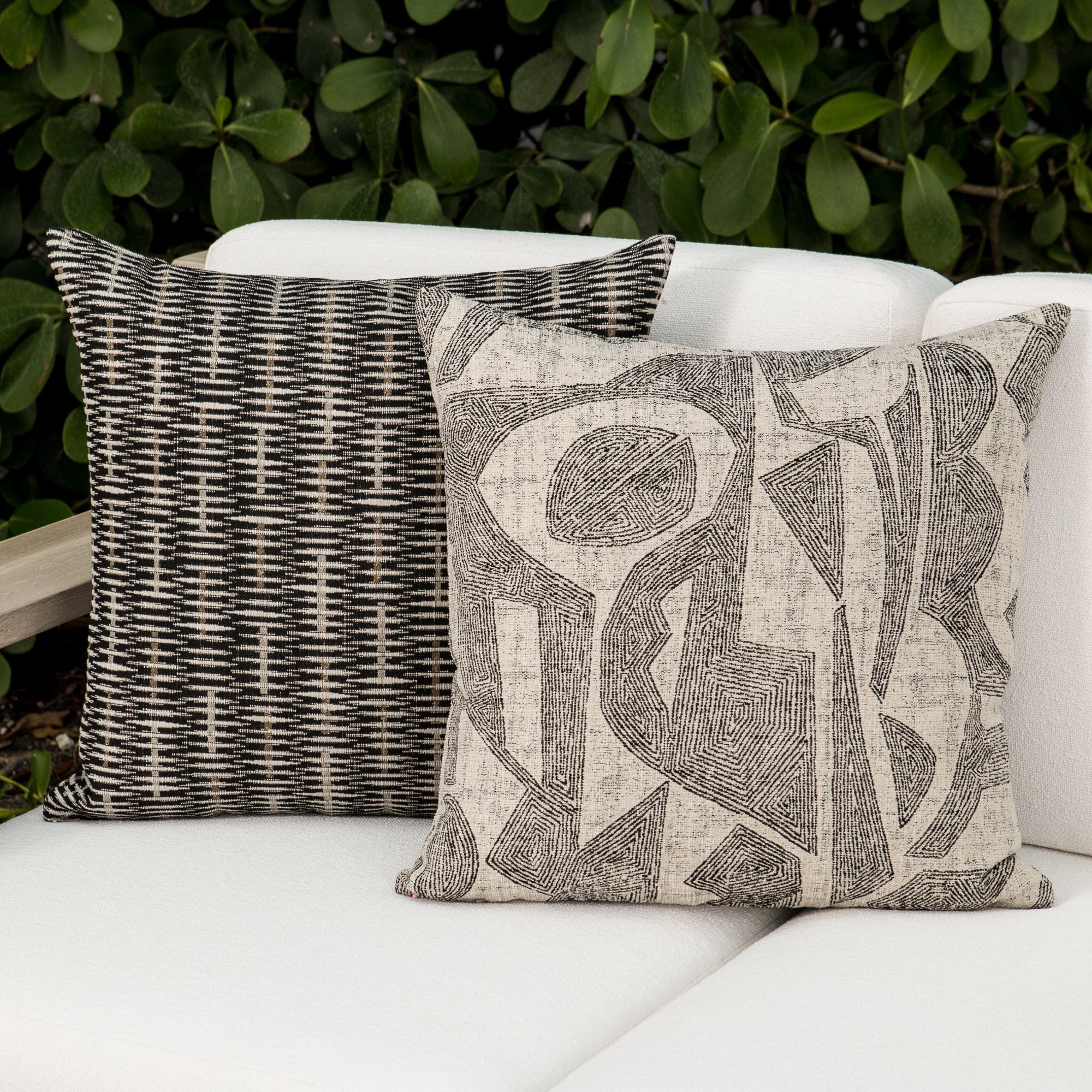 Luxury neutral botanical patterned pillows on a outdoor sofa, featuring rich texture for layered decor for indoor and outdoor use