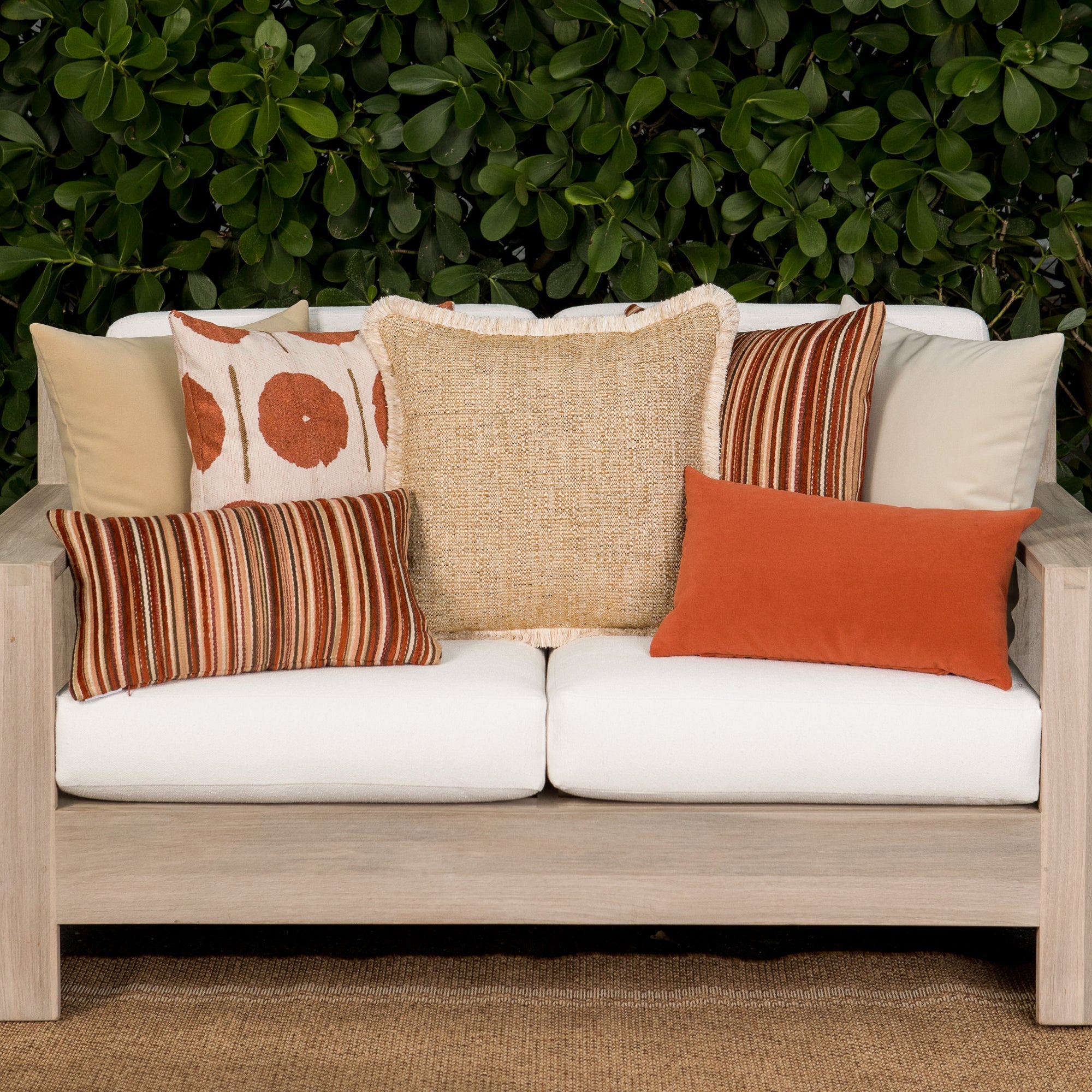 Luxury ouutdoor safe velvet accent cushions on a rooftop seating area, featuring soft touch performance weave for residential and commercial interiors