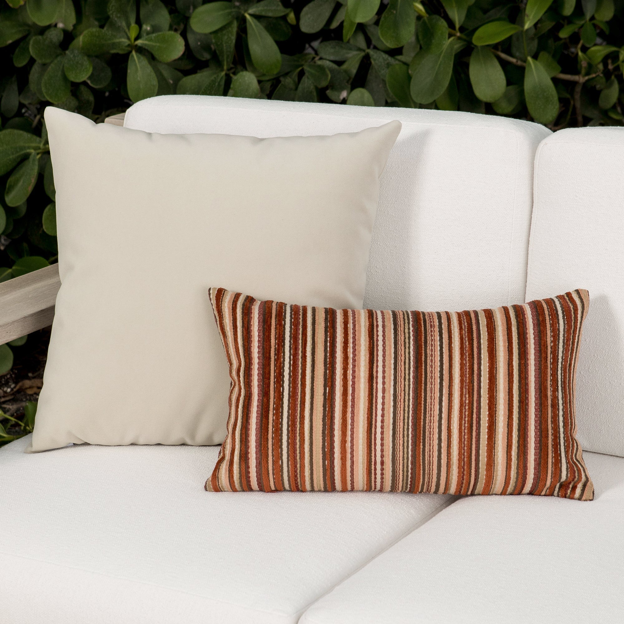 Luxury ouutdoor safe velvet accent cushions on a rooftop seating area, featuring soft touch performance weave for residential and commercial interiors