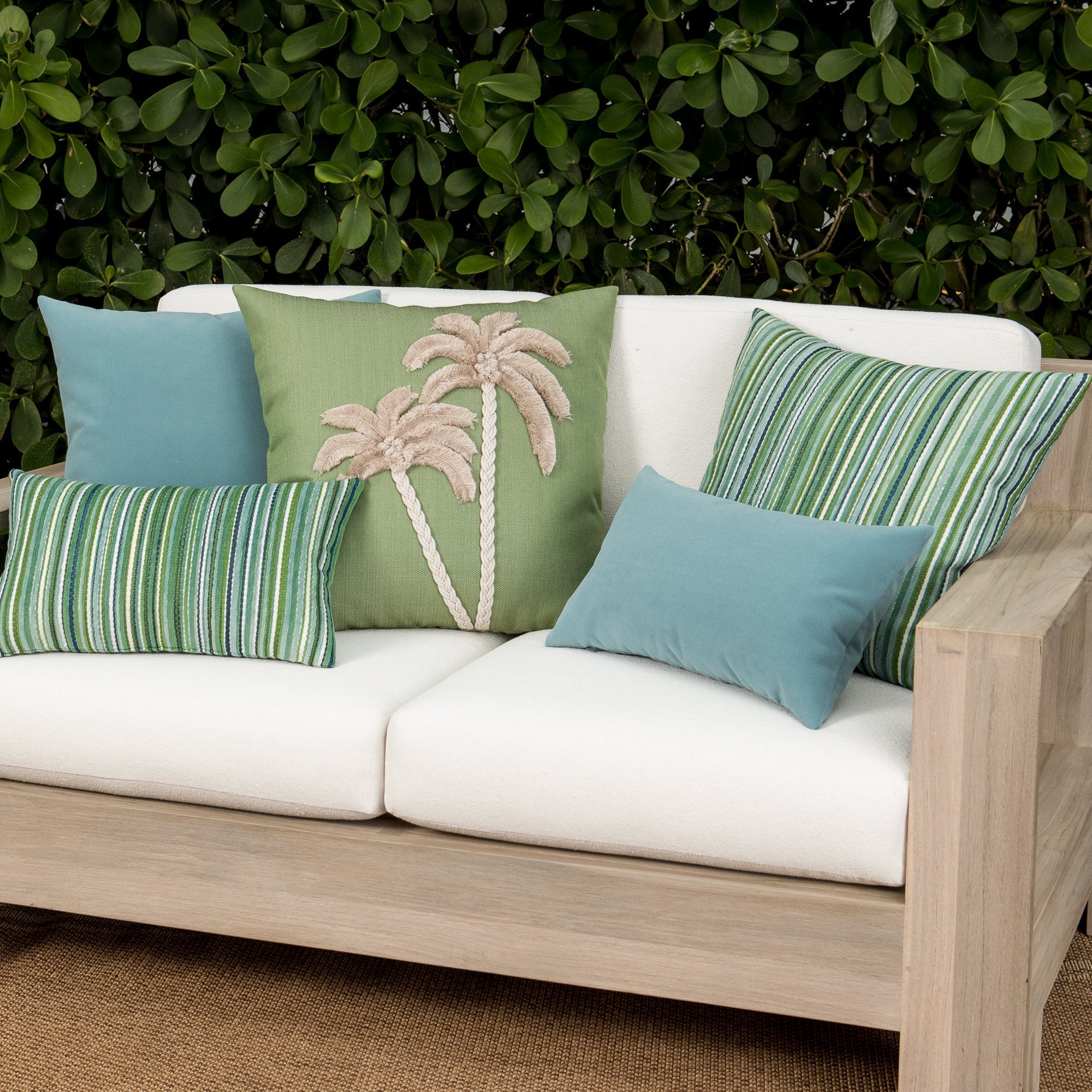 Luxury ouutdoor safe velvet accent cushions on a rooftop seating area, featuring soft touch performance weave for residential and commercial interiors