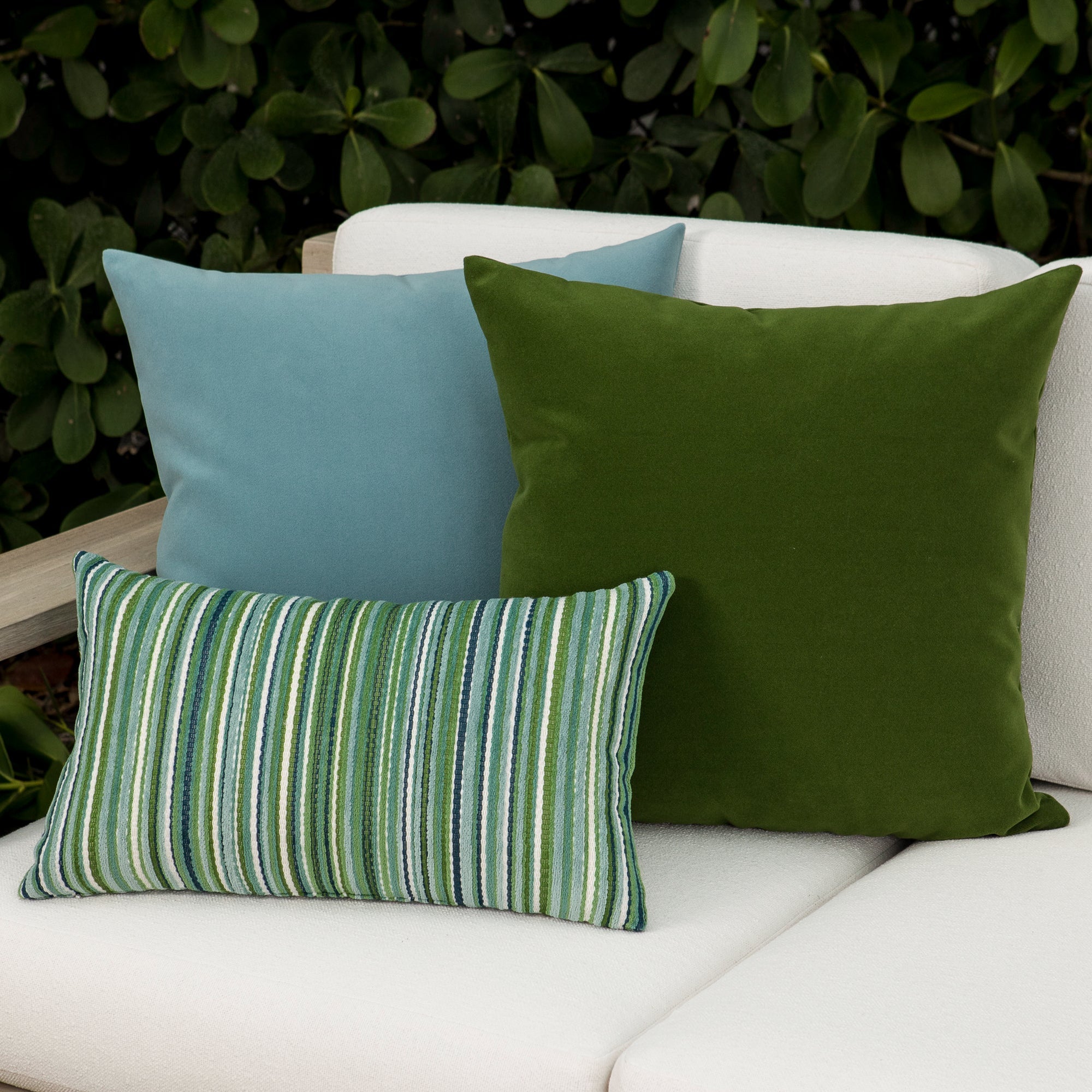 Luxury ouutdoor safe velvet accent cushions on a rooftop seating area, featuring soft touch performance weave for residential and commercial interiors