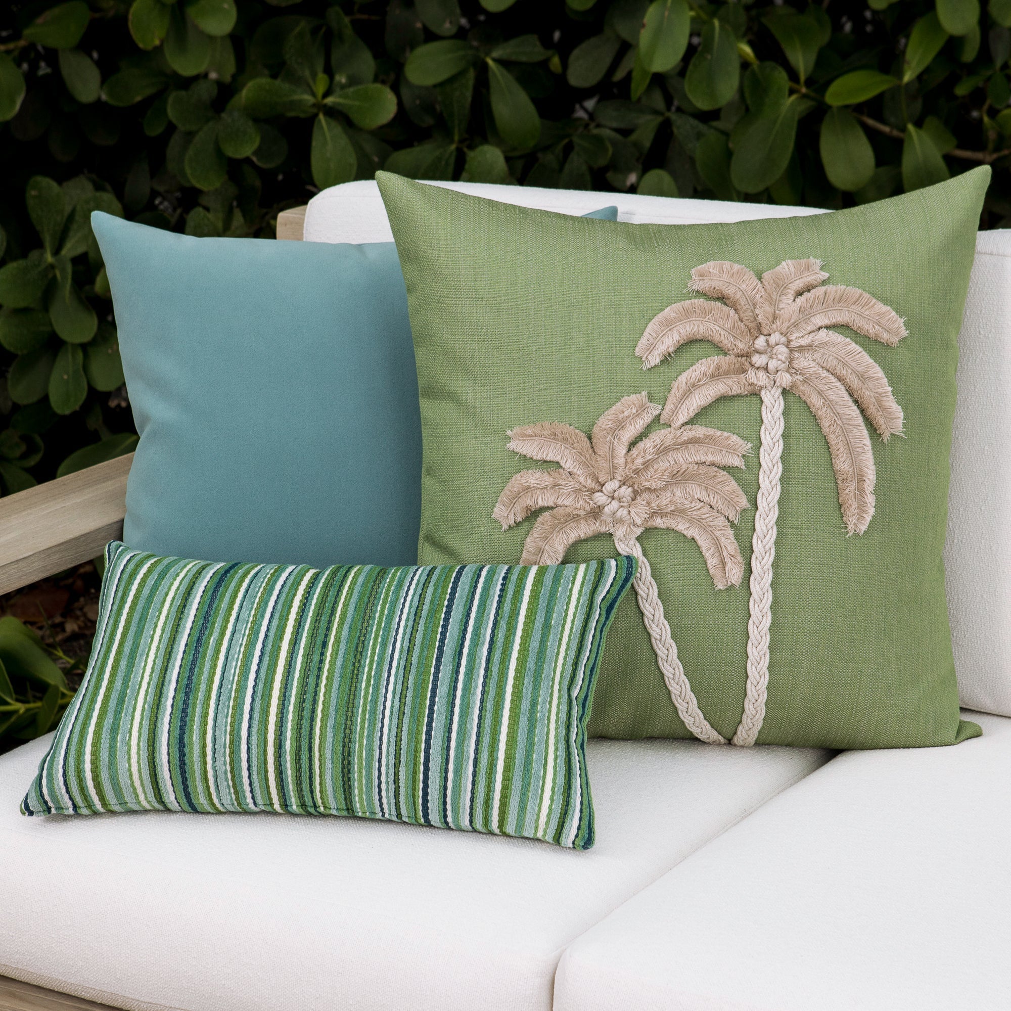 Luxury ouutdoor safe velvet accent cushions on a rooftop seating area, featuring soft touch performance weave for residential and commercial interiors