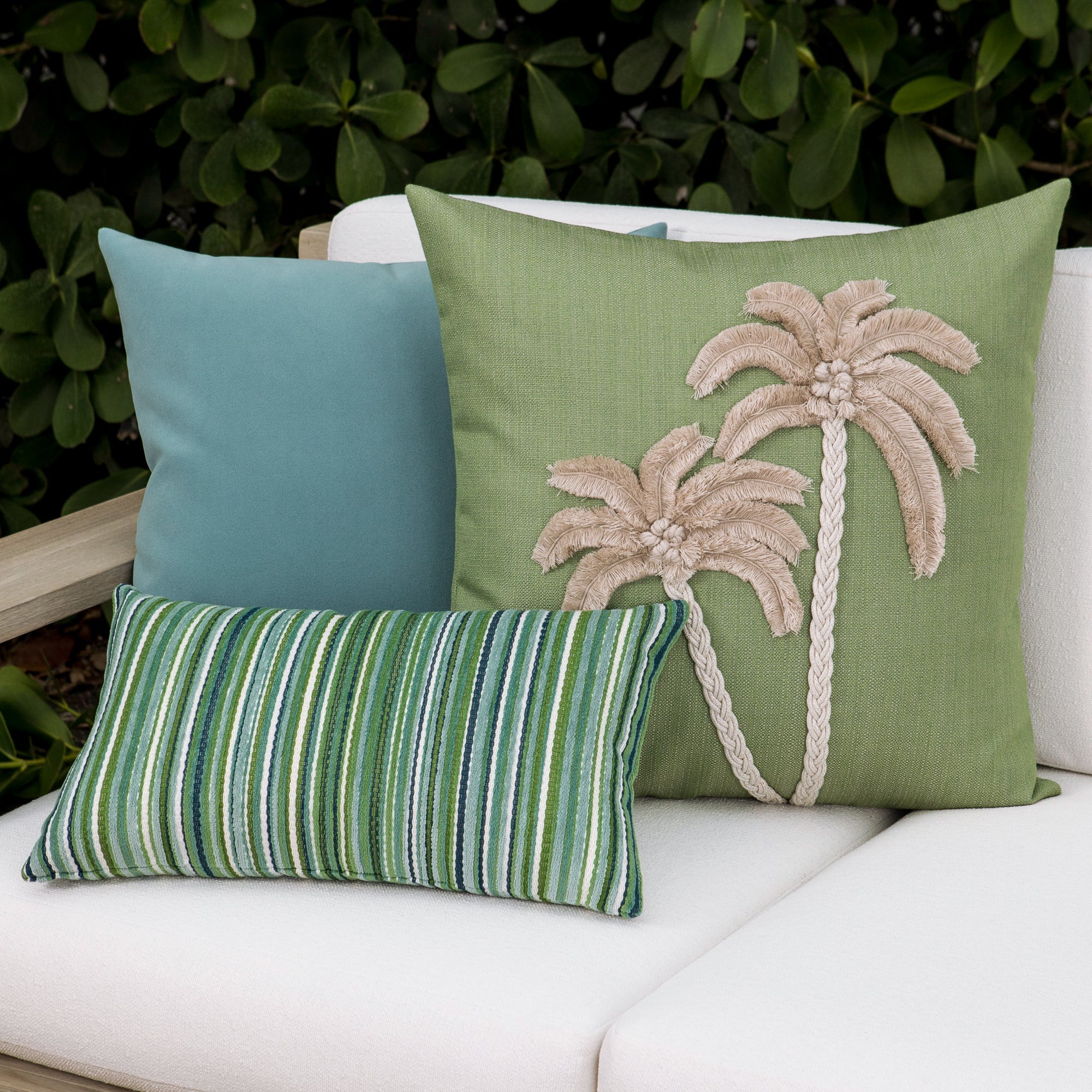 Luxury ouutdoor safe velvet accent cushions on a rooftop seating area, featuring soft touch performance weave for residential and commercial interiors