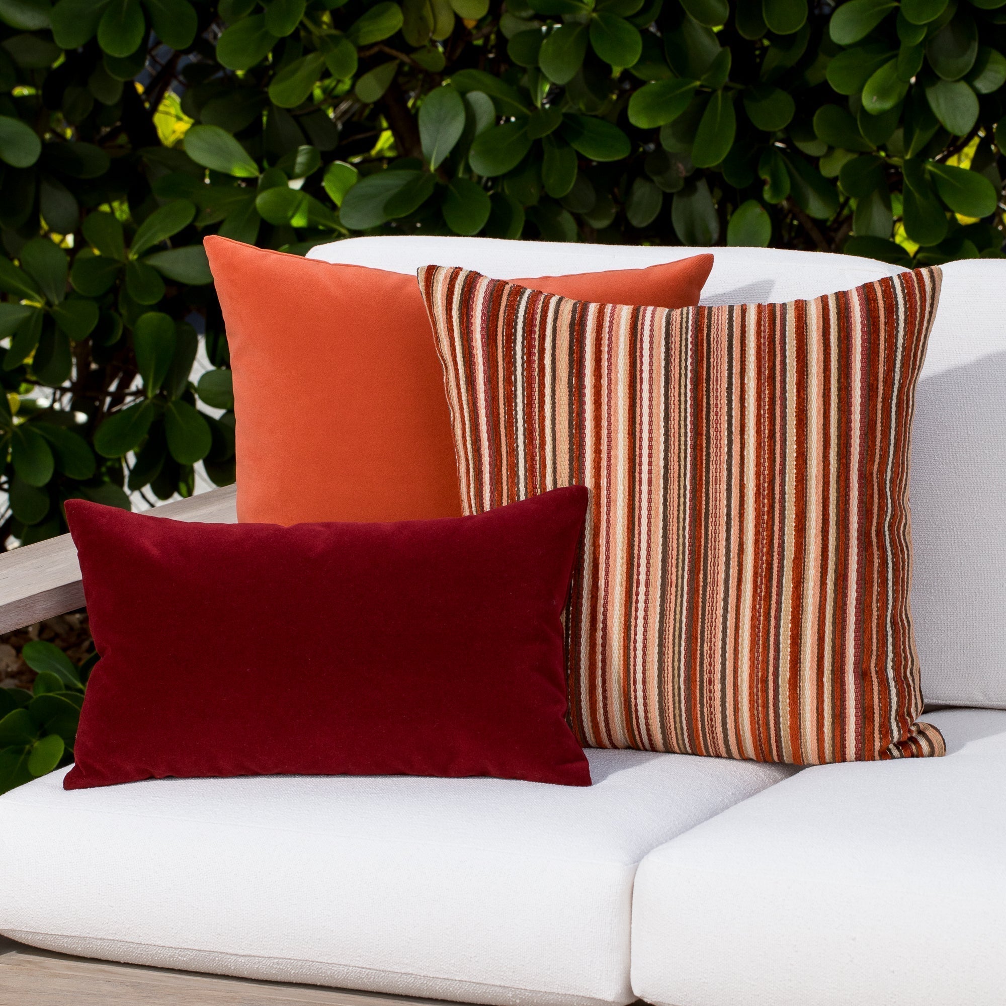 Luxury ouutdoor safe velvet accent cushions on a rooftop seating area, featuring soft touch performance weave for residential and commercial interiors