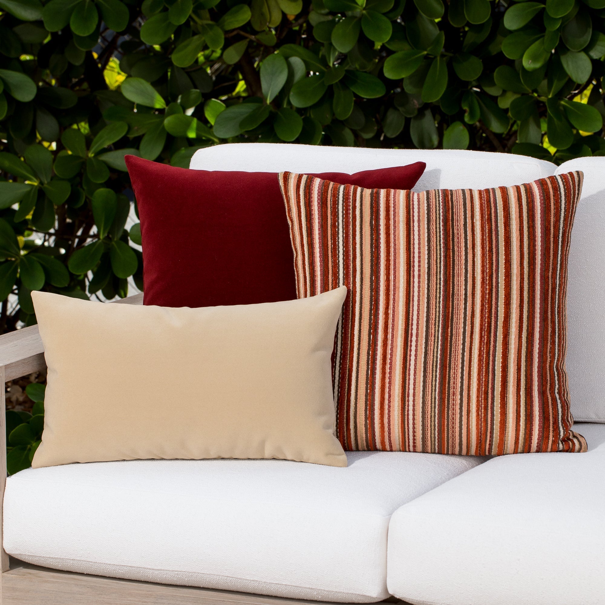 Luxury ouutdoor safe velvet accent cushions on a rooftop seating area, featuring soft touch performance weave for residential and commercial interiors