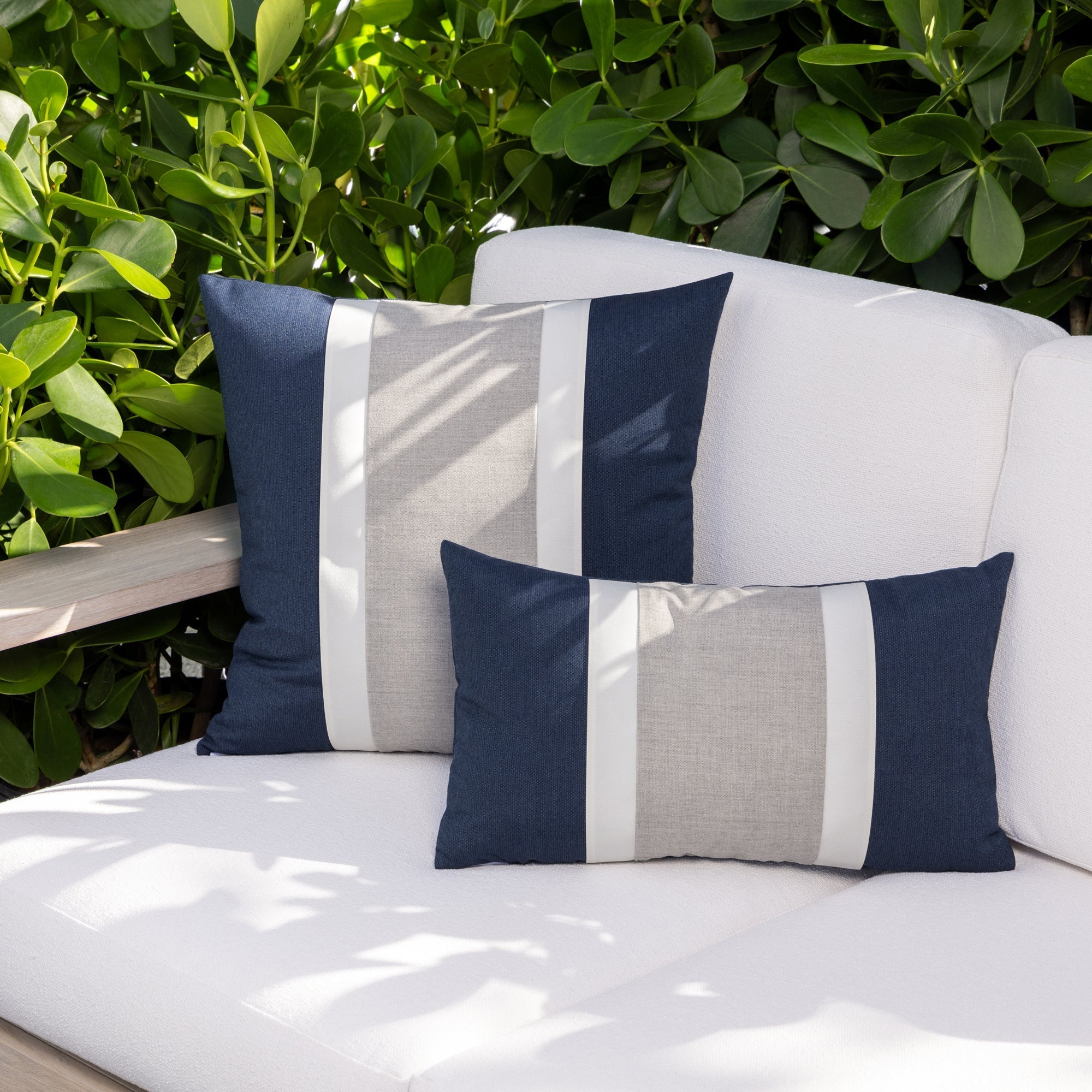 Luxury neutral striped cushion on a hotel lobby banquette, featuring weather resistant performance fabric for indoor and outdoor use by Elaine Smith