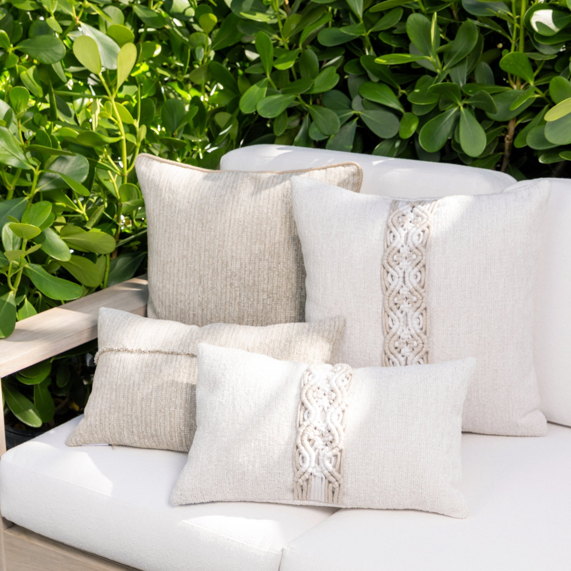 Luxury navy blue botanical patterned and neutral accent pillow on a outdoor sofa, featuring easy clean performance fabric for luxury hotel and resort design by Elaine Smith