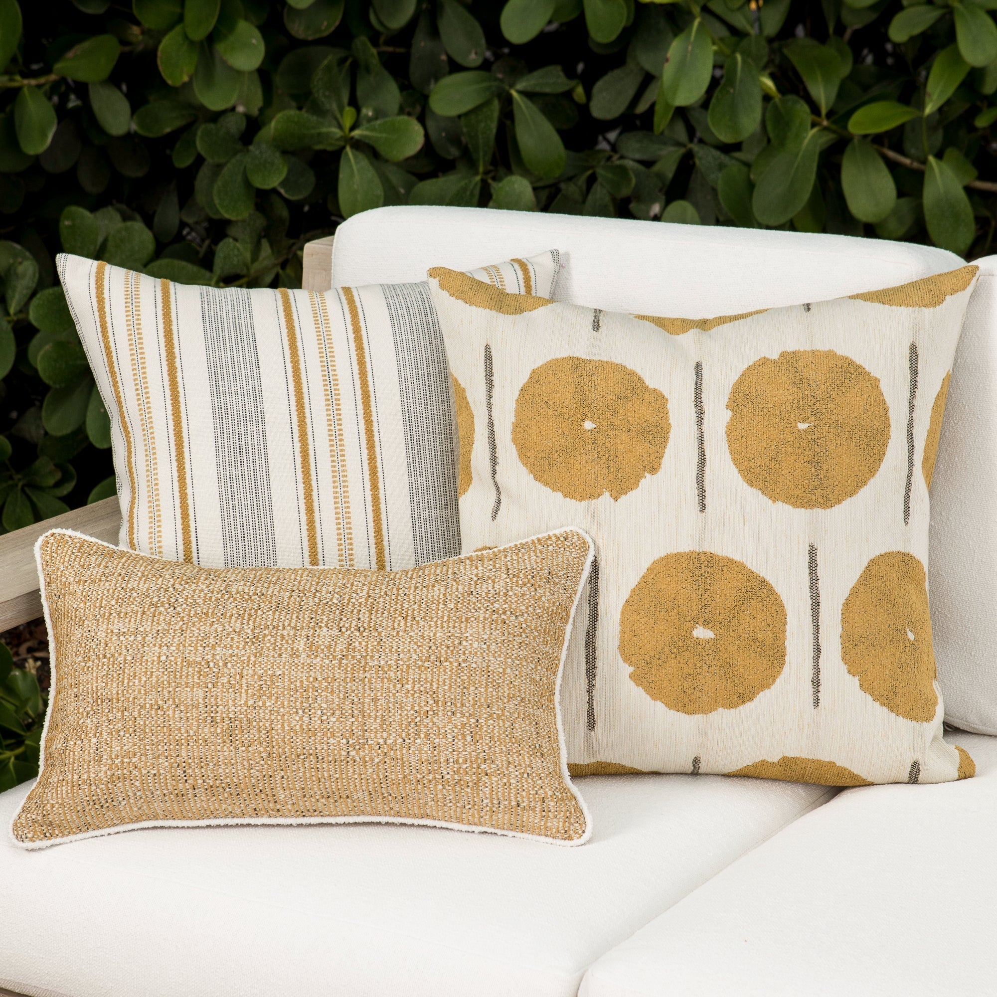 Luxury gold and ivory textured woven cushion on a outdoor sofa, featuring tailored seams for a polished look to complete indoor and outdoor decor by Elaine Smith