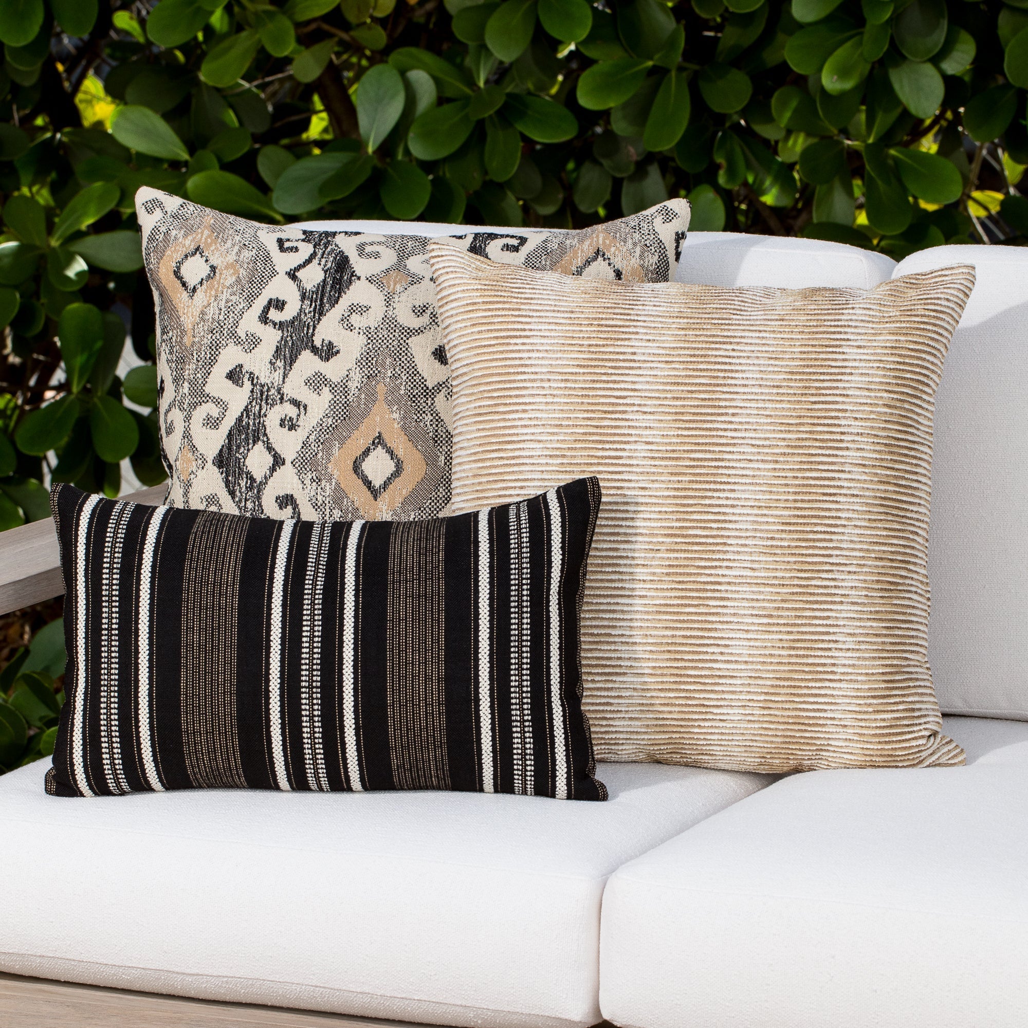 Luxury black and ivory textured woven cushion on a outdoor sofa, featuring tailored seams for a polished look to complete indoor and outdoor decor by Elaine Smith