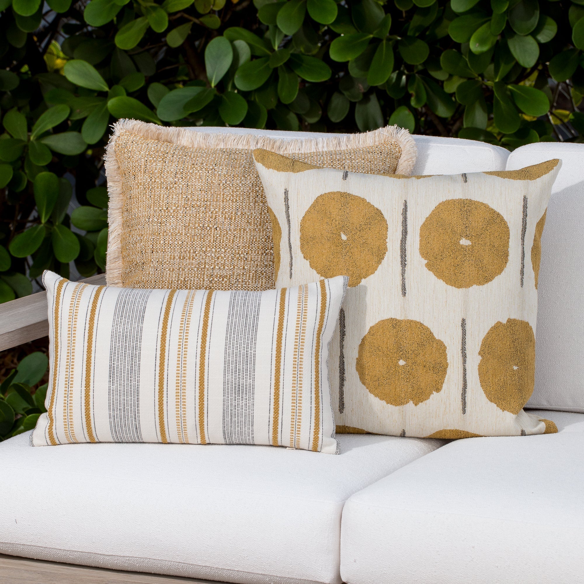 Luxury gold and ivory textured woven cushion on a outdoor sofa, featuring tailored seams for a polished look to complete indoor and outdoor decor by Elaine Smith