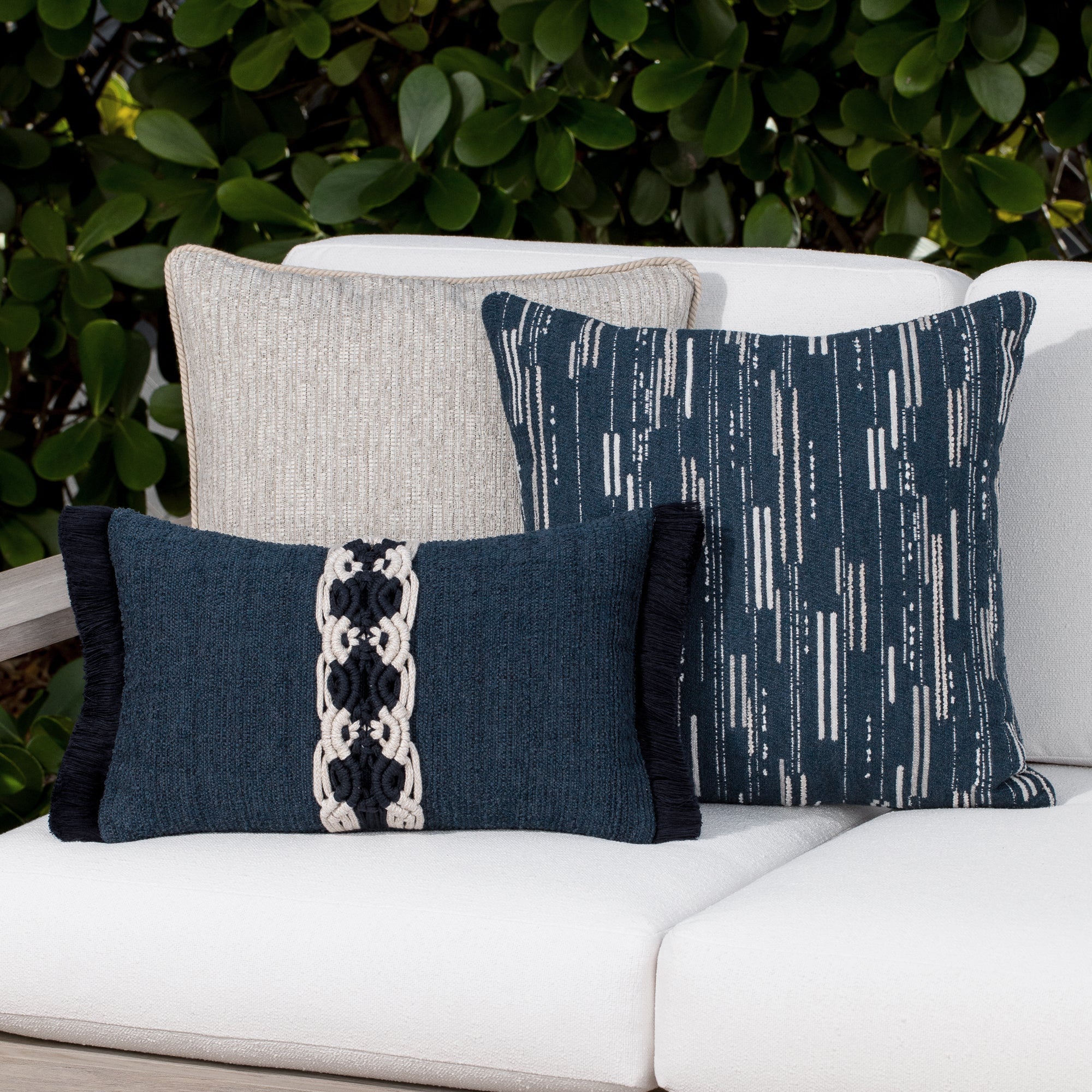 Luxury indigo classic patterned bolster pillow on a rooftop seating area, featuring rich texture for layered decor for indoor and outdoor use