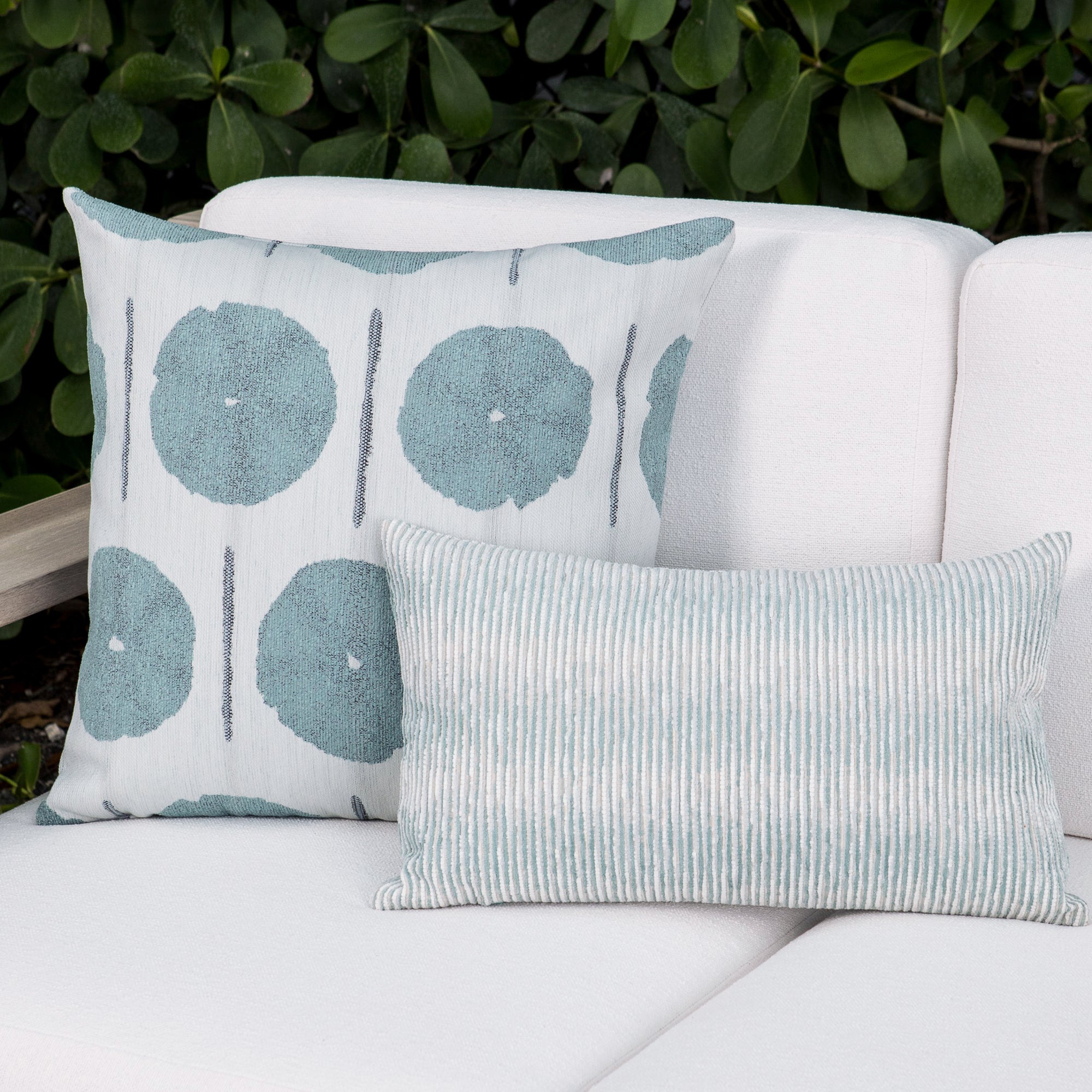 Luxury light blue and ivory solid throw pillow on a outdoor sofa, featuring plush fill for lasting comfort for hospitality and commercial spaces