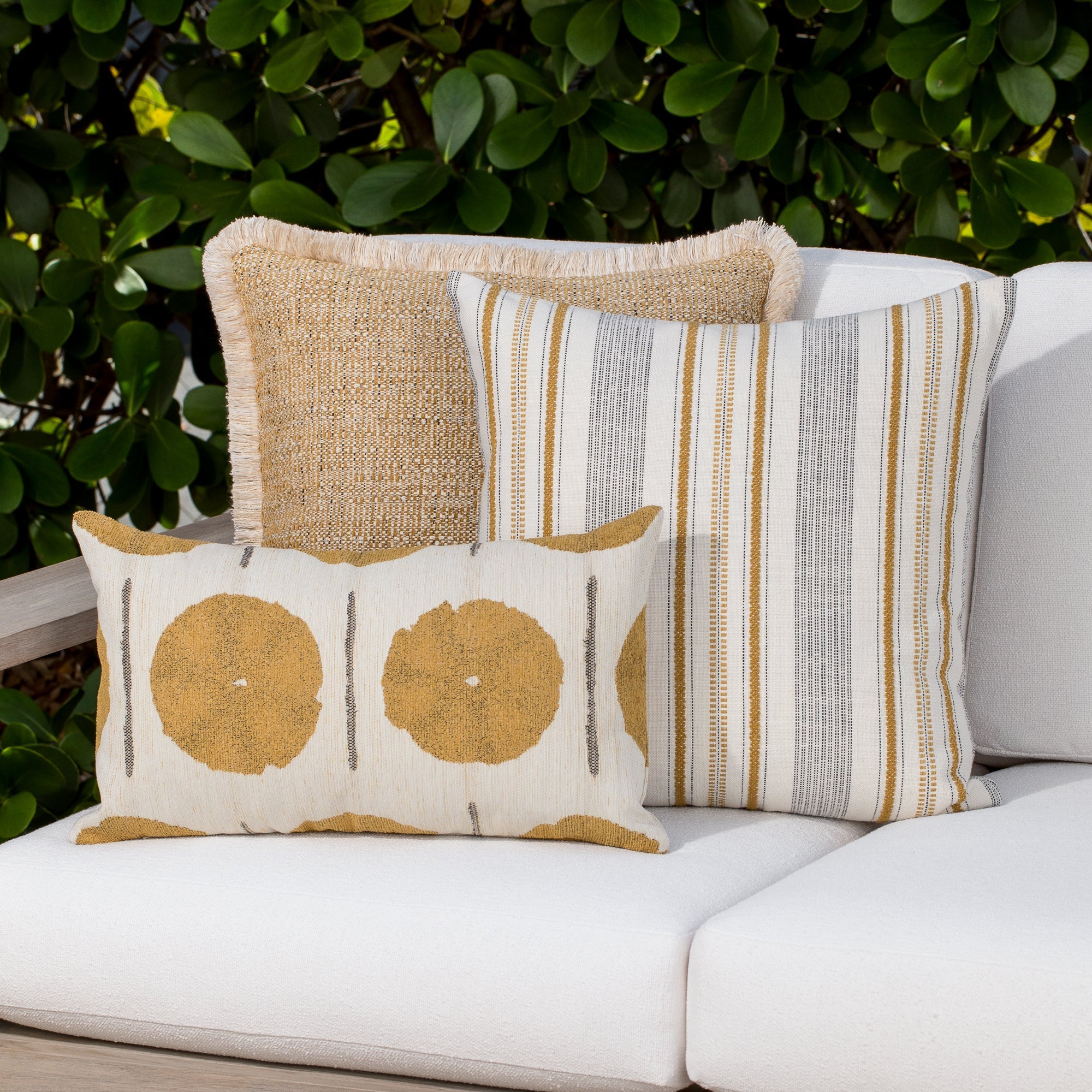 Luxury gold and ivory striped cushion on a outdoor sofa, featuring commercial grade construction for luxury hotel and resort design