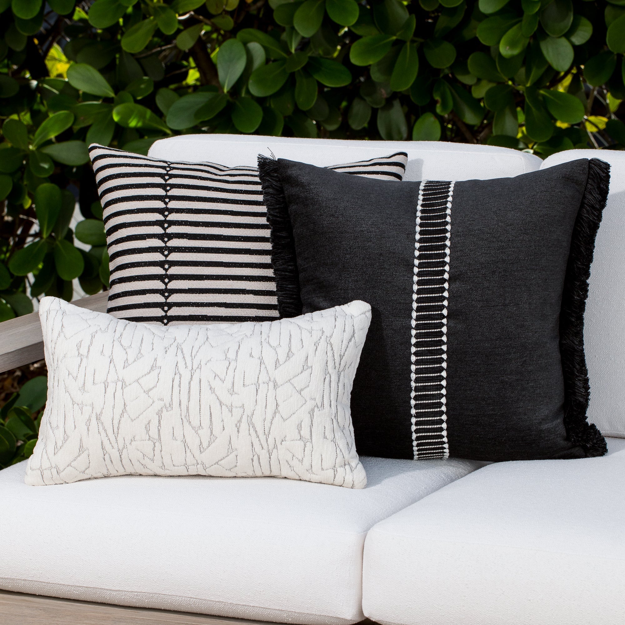 Outdoor image of pillows in Deep charcoal luxury velour fabric for outdoor safe use