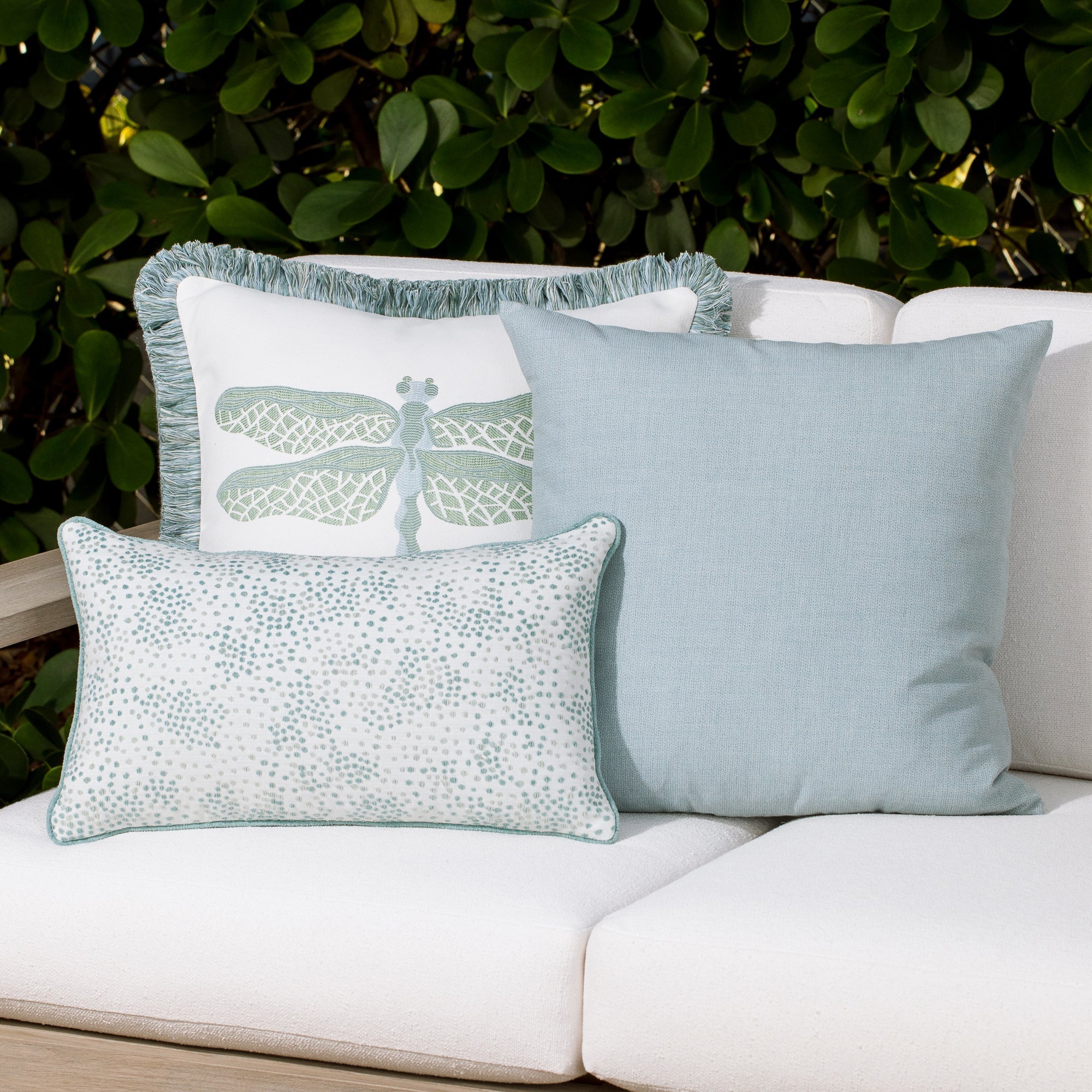 Luxury blue and green and ivory subtle patterned bolster pillow on a resort cabana dayoutdoor sofa, featuring plush fill for lasting comfort for hospitality and commercial spaces