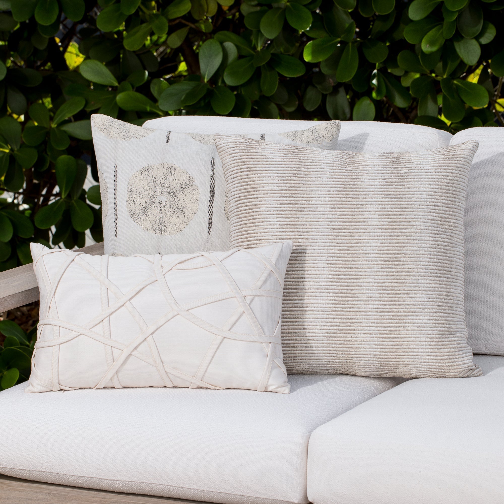 Luxury ivory classic patterned pillows on a outdoor sofa, featuring UV and fade resistant fabric to complete indoor and outdoor decor