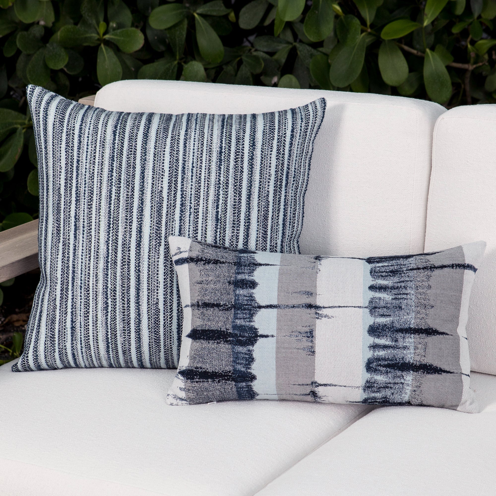 Luxury indigo and white striped throw pillow on a hotel lobby banquette, featuring plush fill for lasting comfort for hospitality and commercial spaces