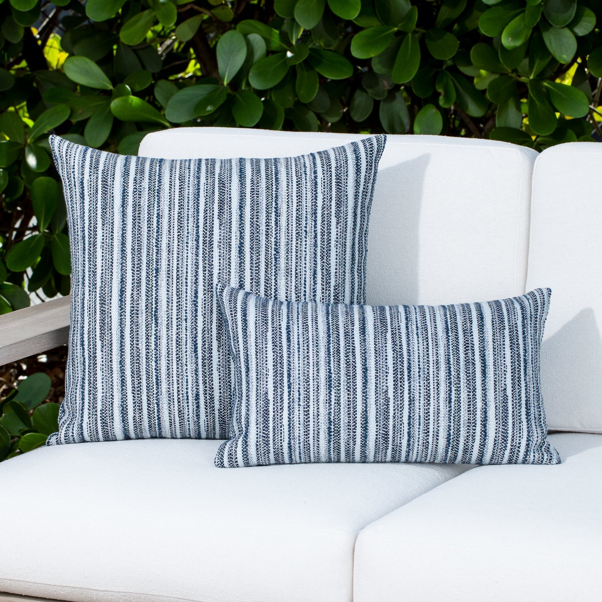 Luxury indigo and white striped throw pillow on a hotel lobby banquette, featuring plush fill for lasting comfort for hospitality and commercial spaces