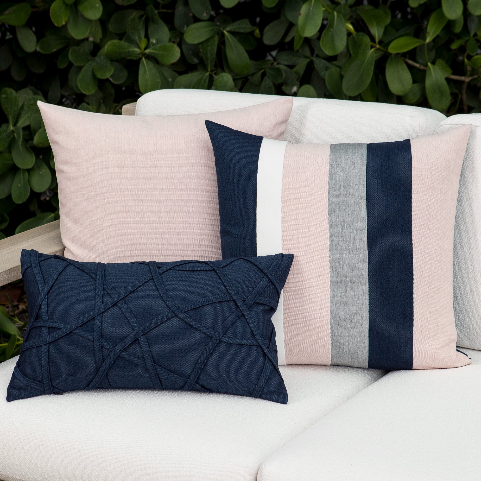 Luxury indigo, pink and gray striped and solid patterned accent pillows on a resort cabana dayoutdoor sofa, featuring commercial grade construction for luxury hotel and resort design