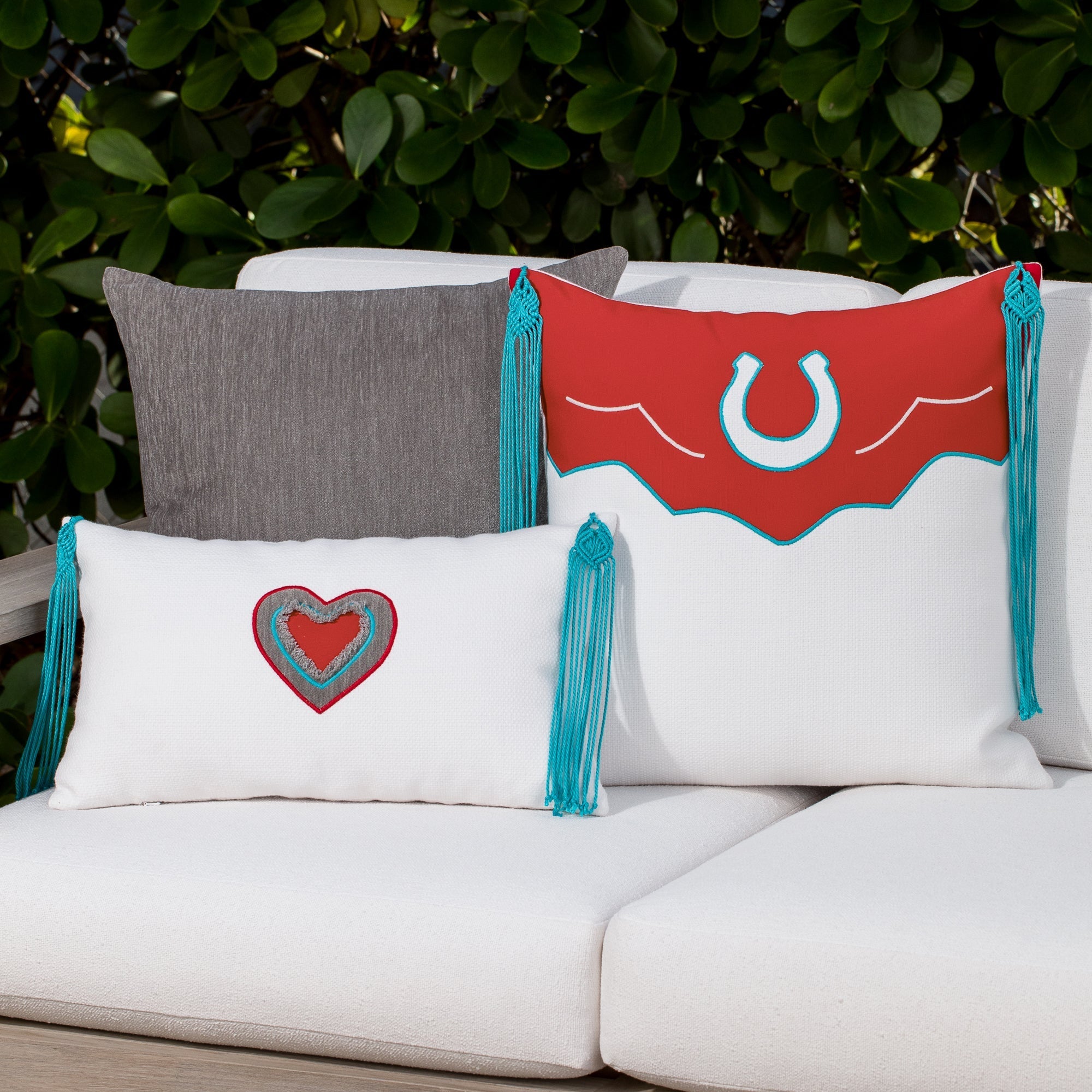 Luxury red, white and gray western patterned pillows on a outdoor sofa styled for hospitality suites, featuring easy clean performance fabric for luxury hotel and resort design by Elaine Smith