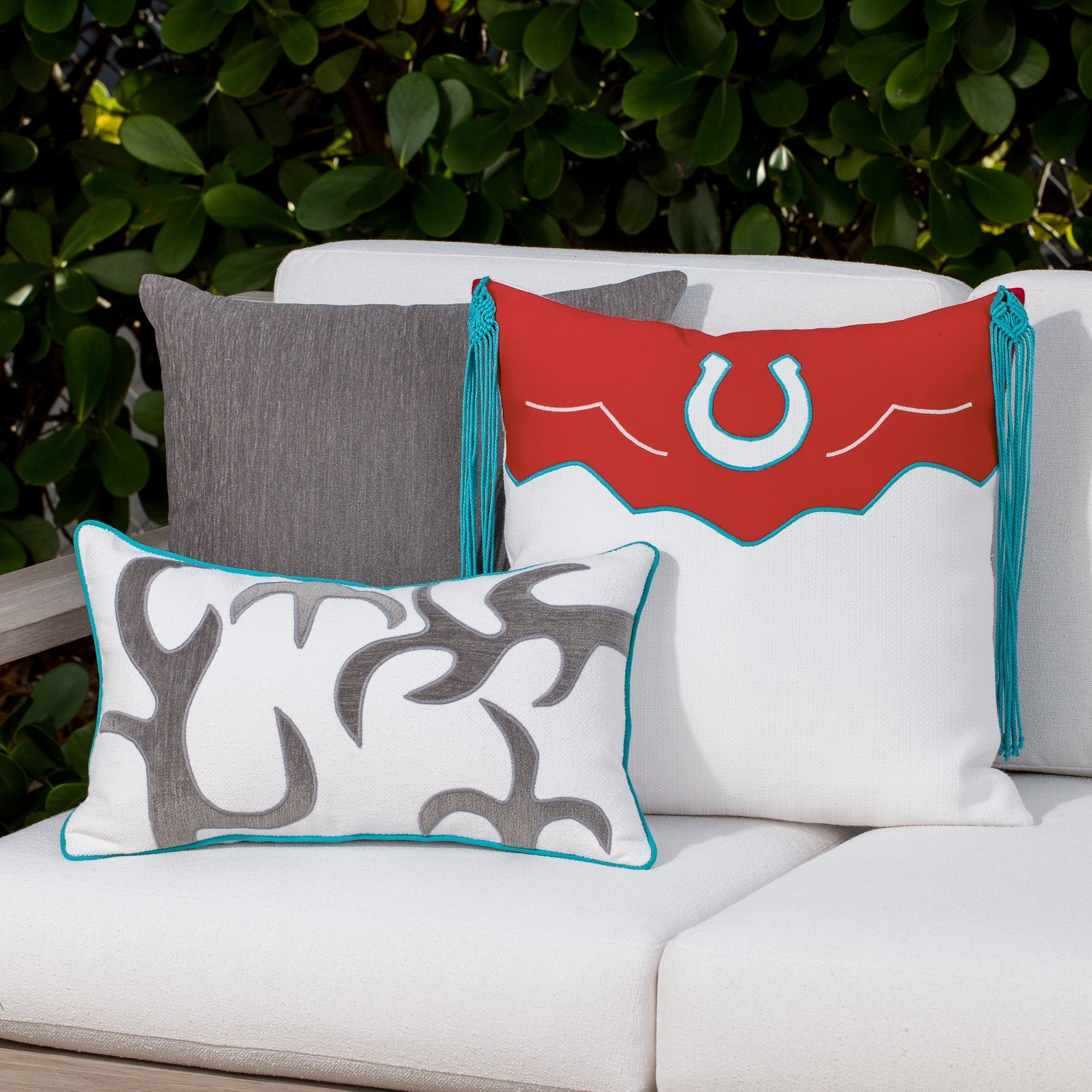 Luxury red, white and gray western patterned pillows on a outdoor sofa styled for hospitality suites, featuring easy clean performance fabric for luxury hotel and resort design by Elaine Smith