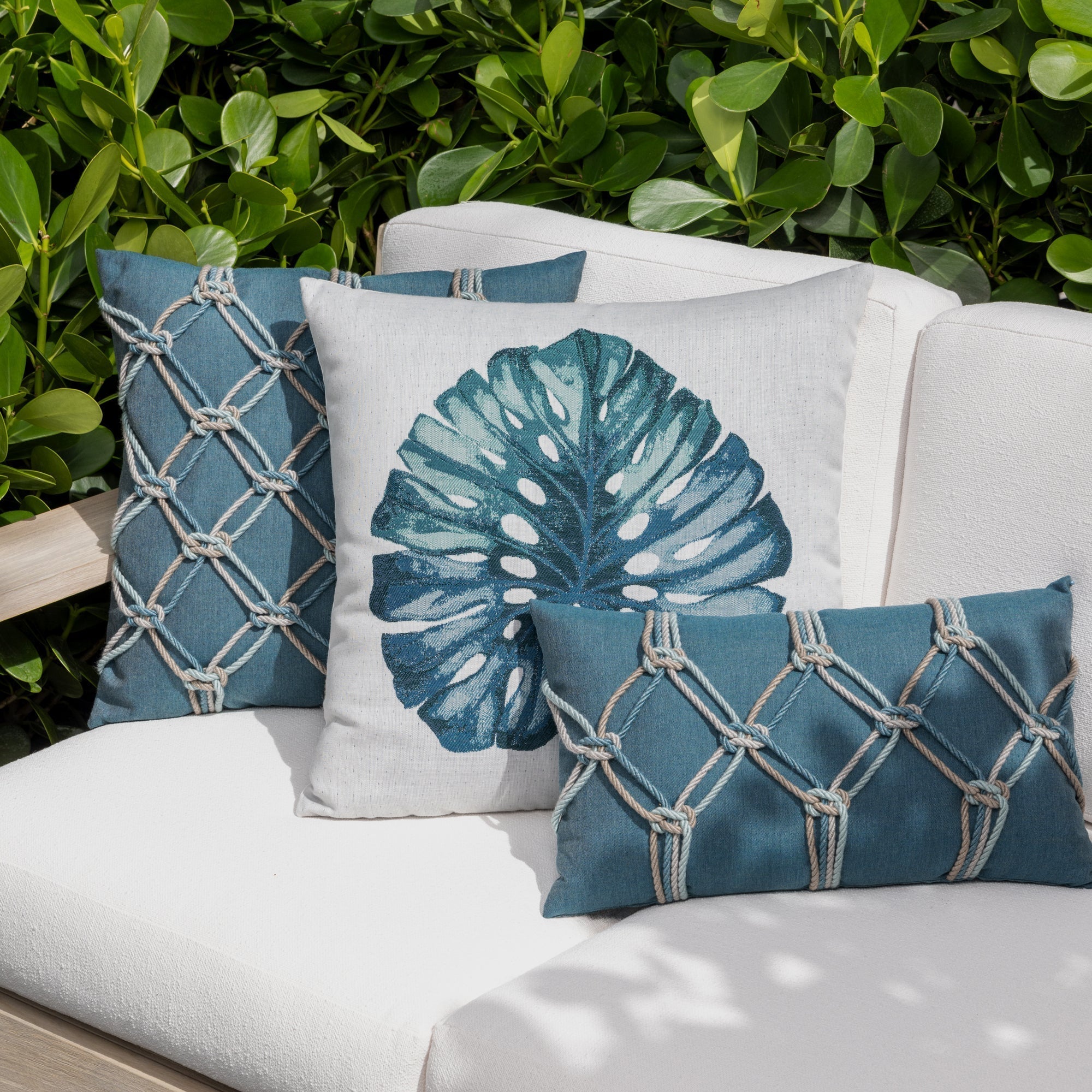 Outdoor image of leaf lagoon and stripe pillows on outdoor sofa